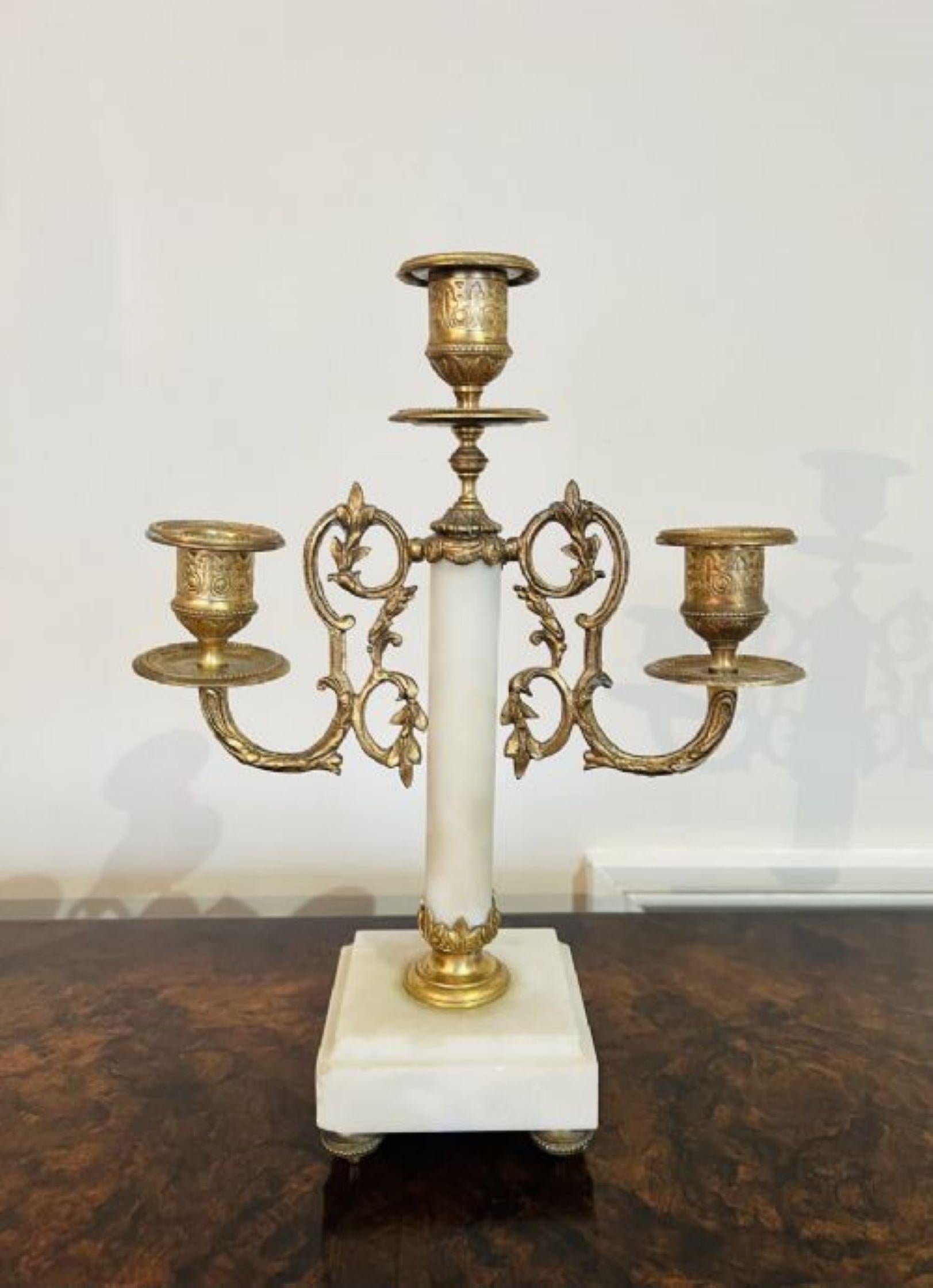 Quality antique Victorian clock garniture with a pair of candelabras standing on onyx bases with ornate brass mounts having a cylinder clock with a 8 day French movement striking the hour and half hour on a bell marked Rouen
Please note all of our