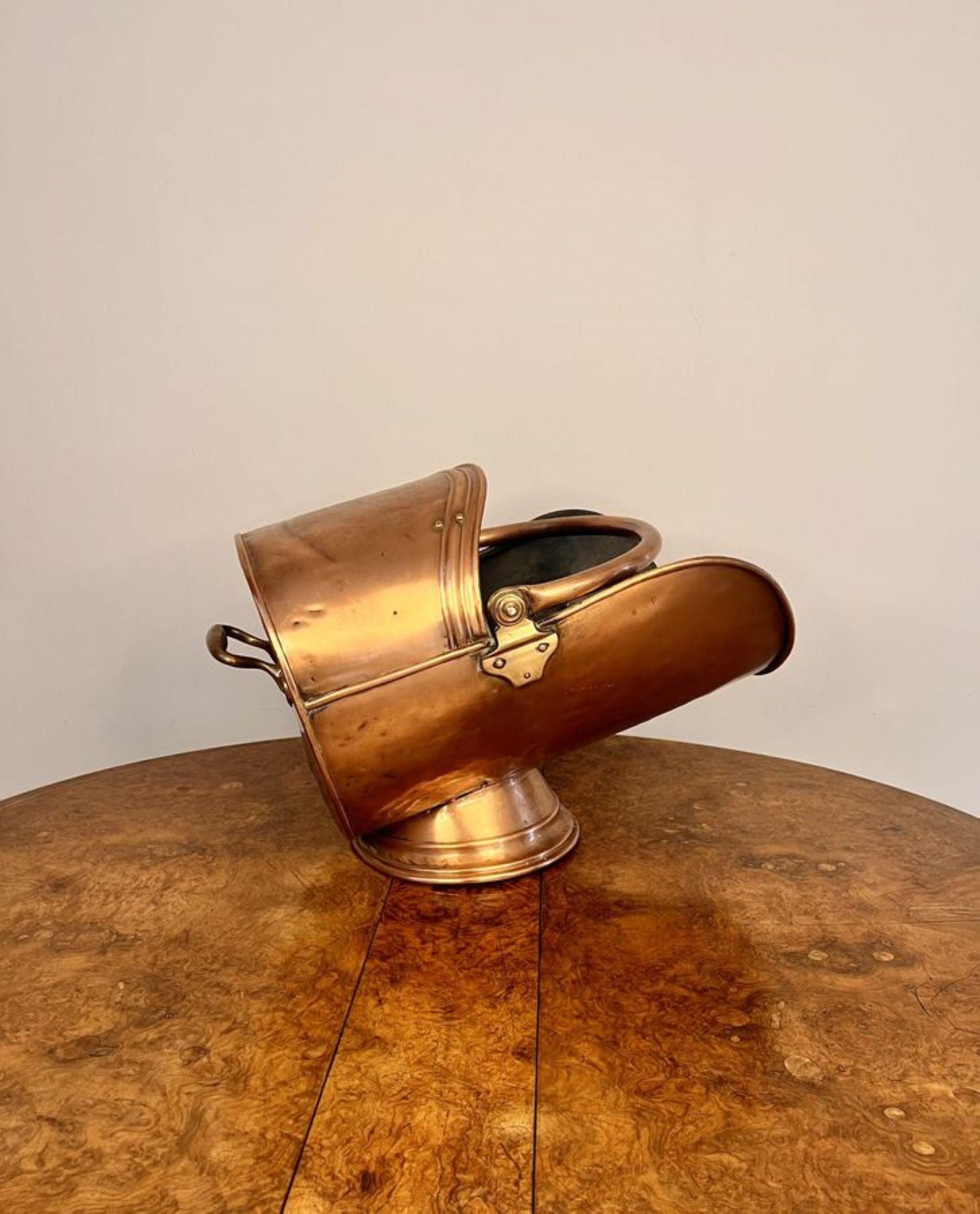 Quality antique Victorian copper coal scuttle having a lovely shaped scuttle raised on a circular base with a carrying handle to the back and a swing handle to the top.

D. 1880
