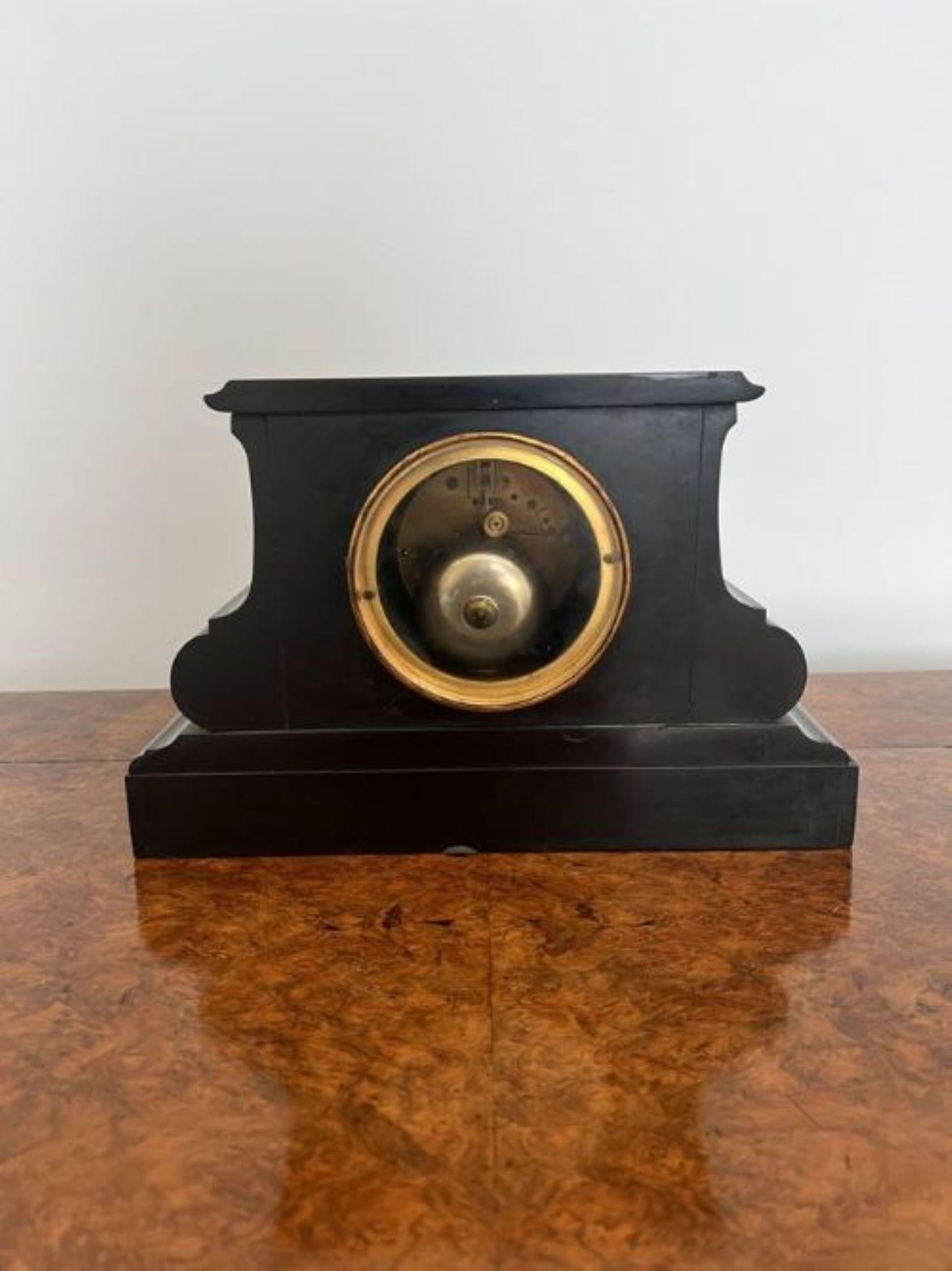 Quality antique Victorian eight day mantle clock having a quality antique Victorian black marble shaped eight day mantle clock with a black dial and gold numerals, a brass bezel and gold hands, with an eight day French movement striking the hour and