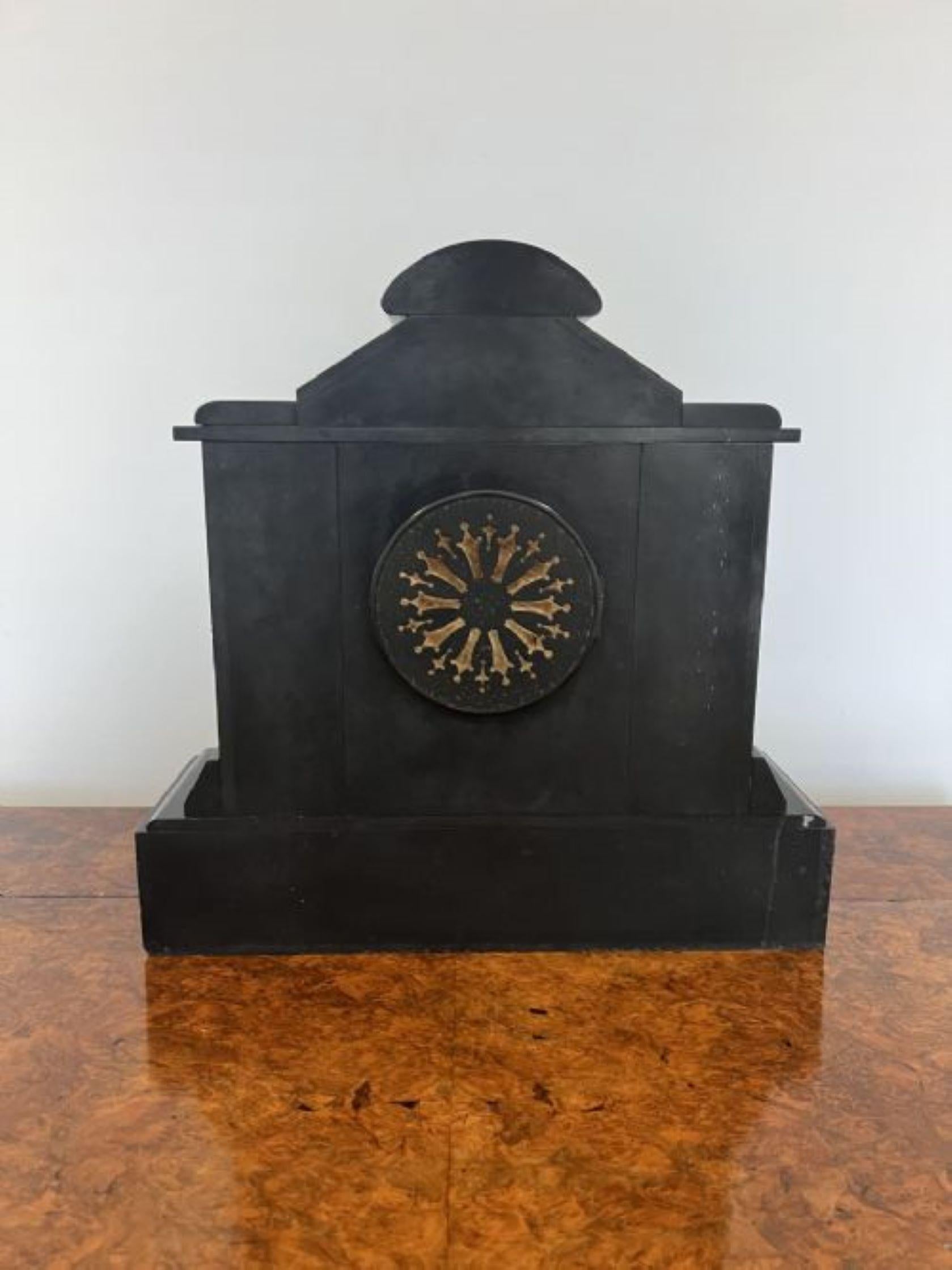 Quality antique Victorian eight day mantle clock having a quality black slate and grey marble cased mantel clock, with a brass bezel and the original hands with Arabic numerals having an eight day movement striking the hour and half hour on a gong.