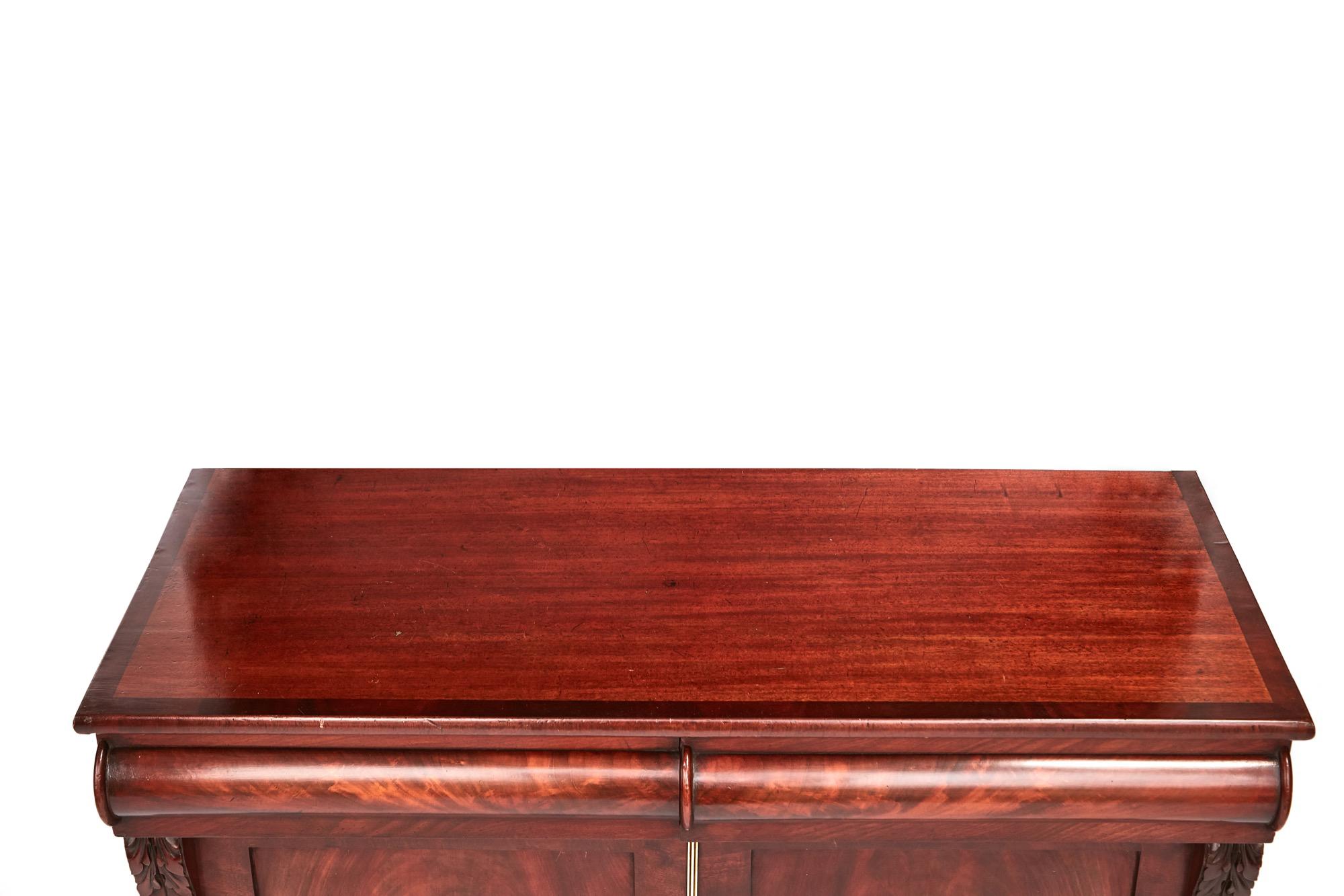 Quality antique Victorian figured mahogany sideboard having a quality mahogany top above two shaped frieze drawers above a pair of figured mahogany panel doors with original brass strip, they open to reveal a fitted interior consisting of two