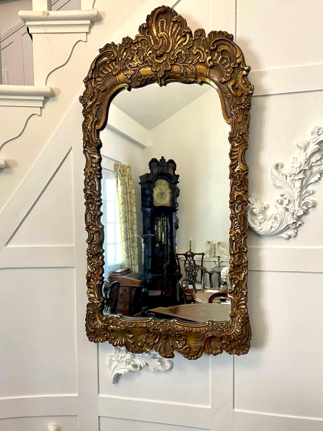 Quality antique gilt gesso framed wall mirror with lovely ornate scrolls and foliage decoration. 

A charming quality example; the original mirror plate being in perfect original condition.

Measures: H 89.5 x W 46.5 x D 3 cm.
1860.
 