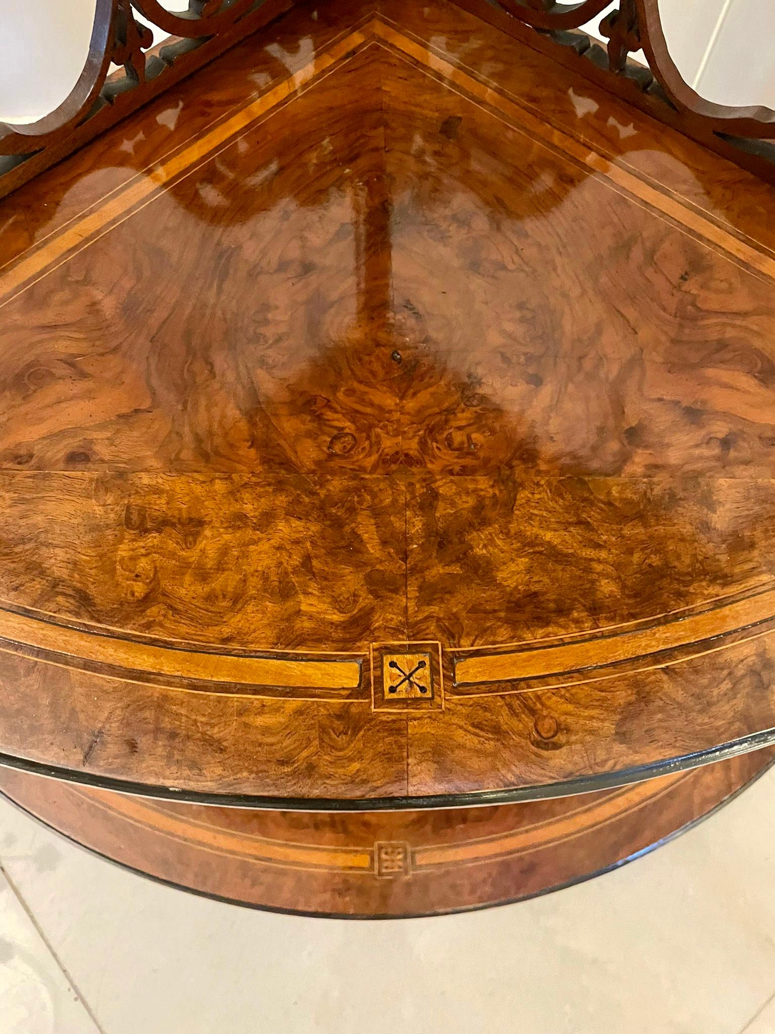 Quality antique Victorian inlaid burr walnut corner whatnot having four quality burr walnut inlaid bow fronted tiers with finely pierced scroll brackets supported by quality turned solid walnut columns. It is raised on turned feet with original