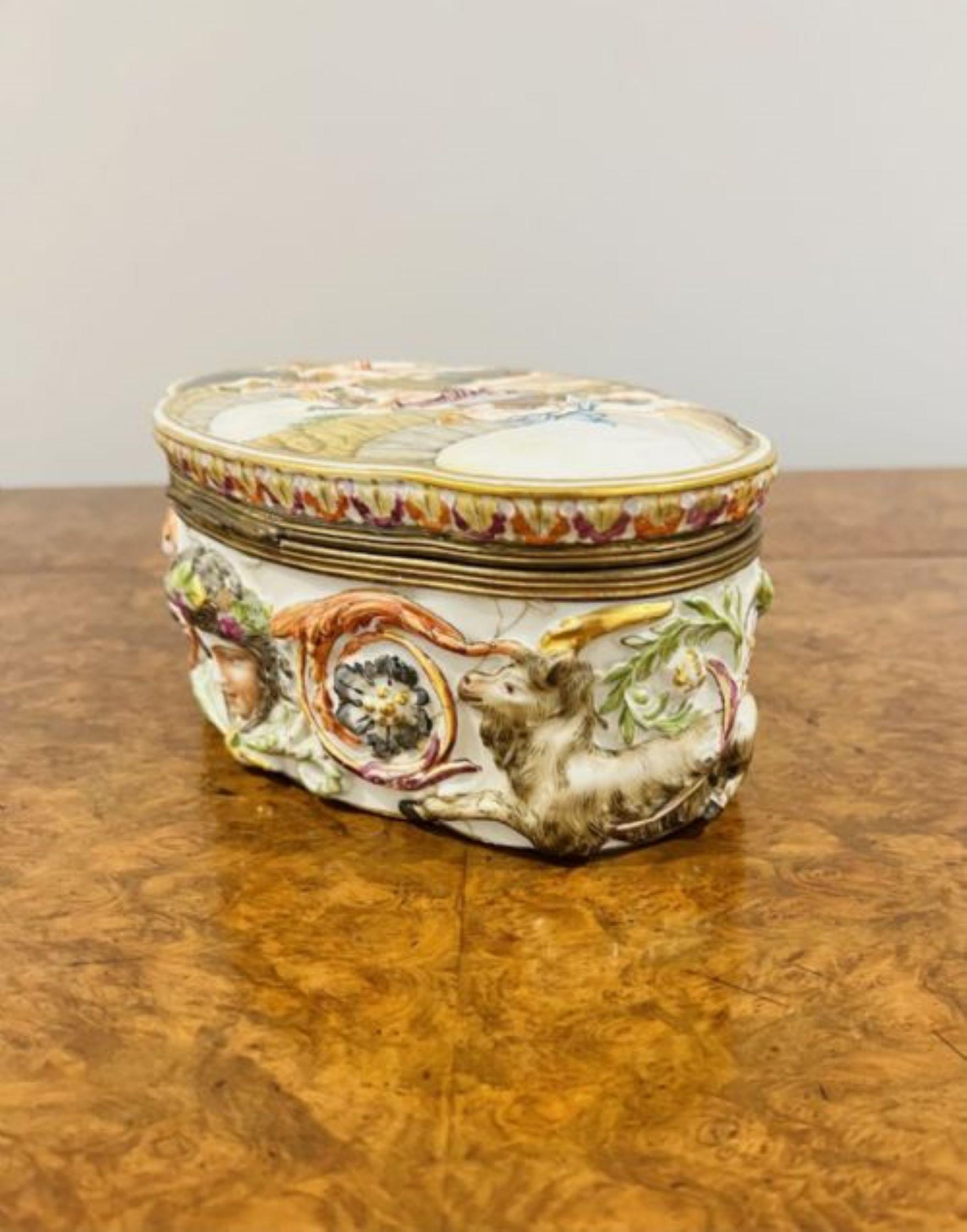 Quality antique Victorian Italian Capodimonte porcelain table casket having a quality antique Victorian Capodimonte porcelain table casket with a clasp to the front opening to reveal one compartment with red velvet interior, having a classical scene