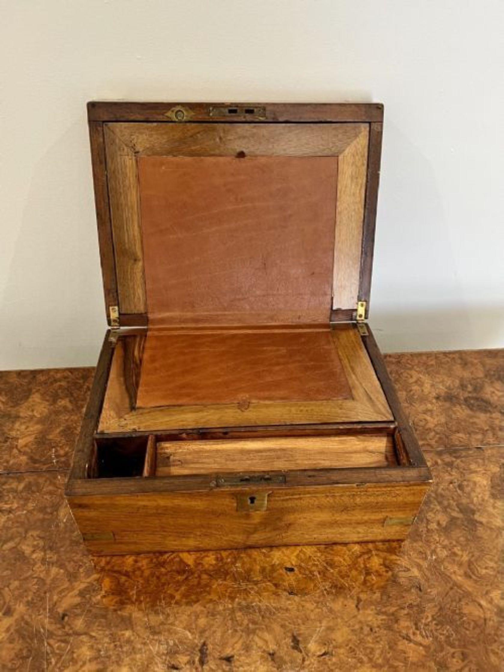 Quality antique Victorian mahogany and brass bound writing box having a quality mahogany writing box with brass bounds opening to reveal a brown leather writing platform and compartmentalised interior