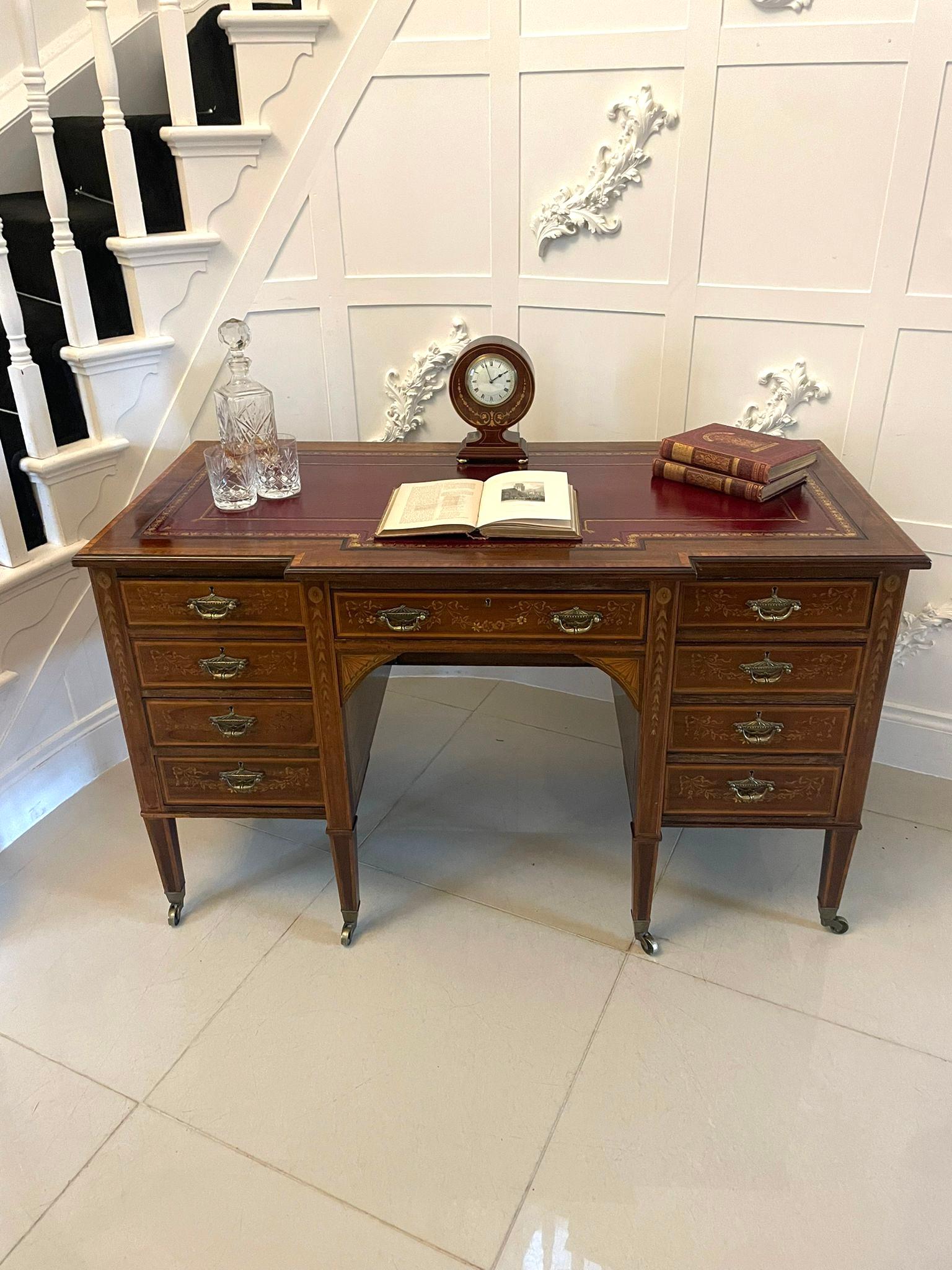 Outstanding quality antique Victorian mahogany inlaid kneehole desk by Edwards and Roberts having a quality mahogany breakfront shaped top crossbanded in satinwood with a red leather writing surface above nine drawers with outstanding quality
