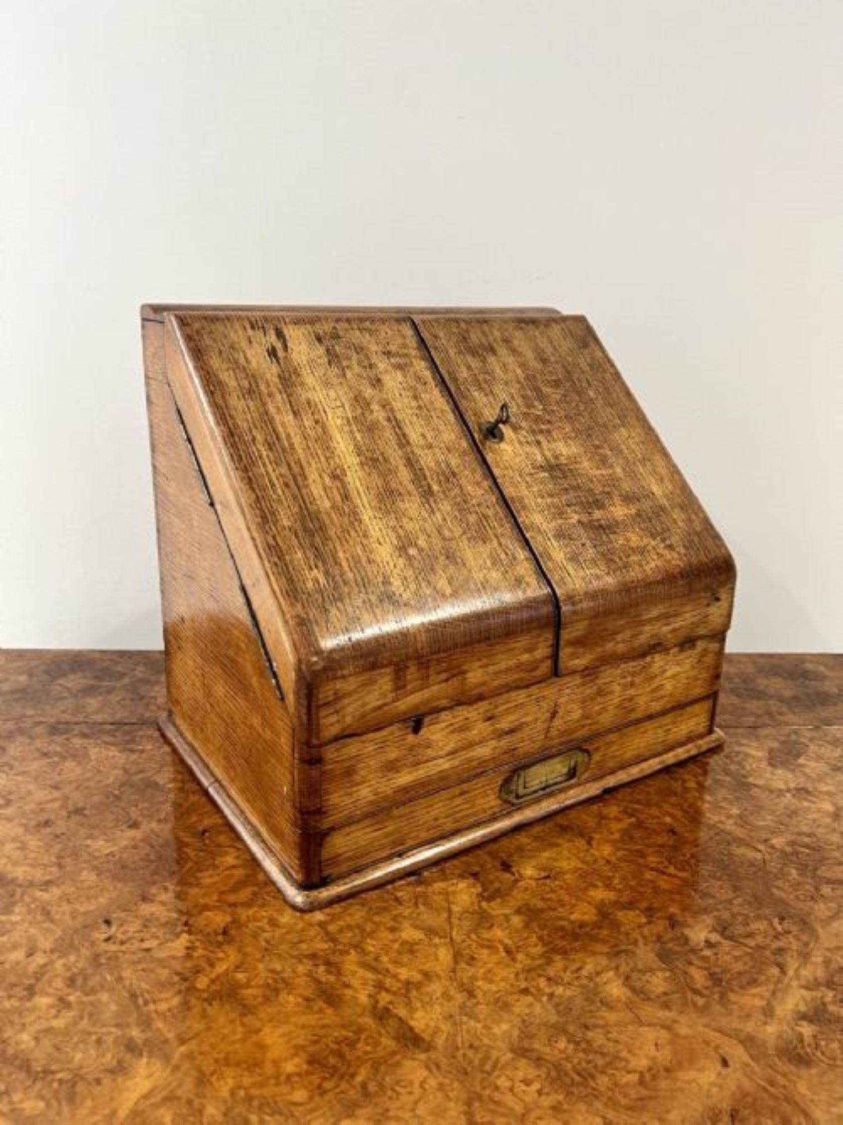 Antique Victorian quality oak stationary box having a sloping front and a pair of oak doors opening to reveal a fitted interior, bearing a presentation plaque to the inside of one of the doors, set dividers, a pair of glass inkwells and a drawer to