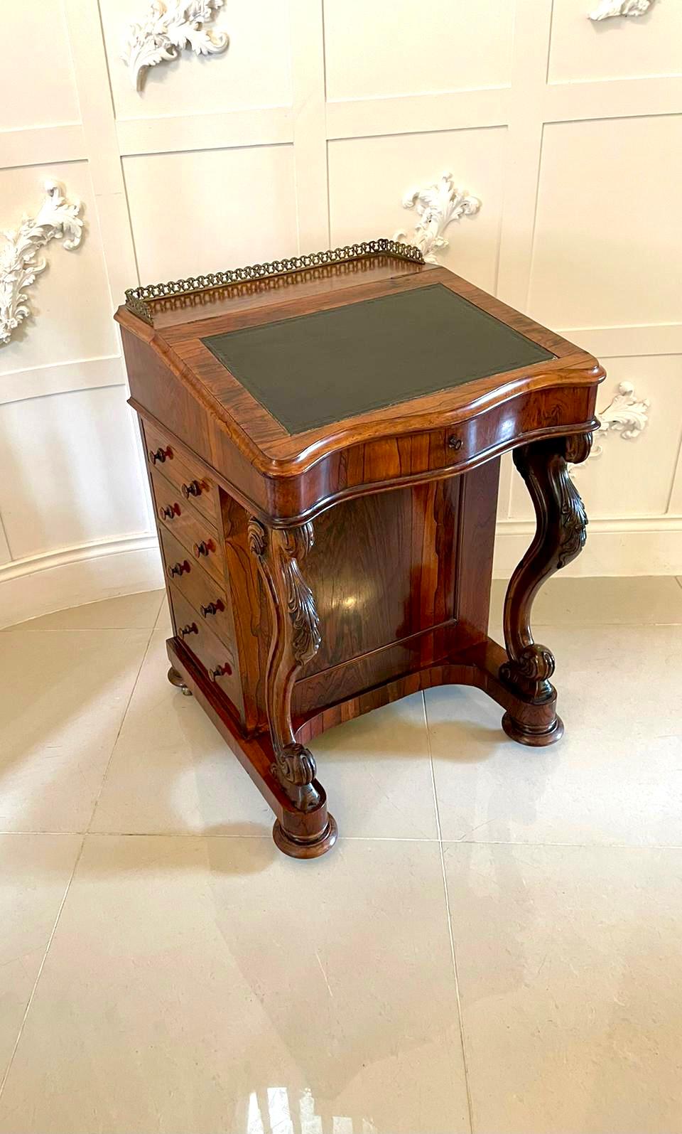 Quality antique Victorian rosewood freestanding davenport having the original brass gallery to the top with lift up serpentine shaped lid and crossbanded rosewood writing slope. The slope opening to reveal a fitted satinwood interior consisting of