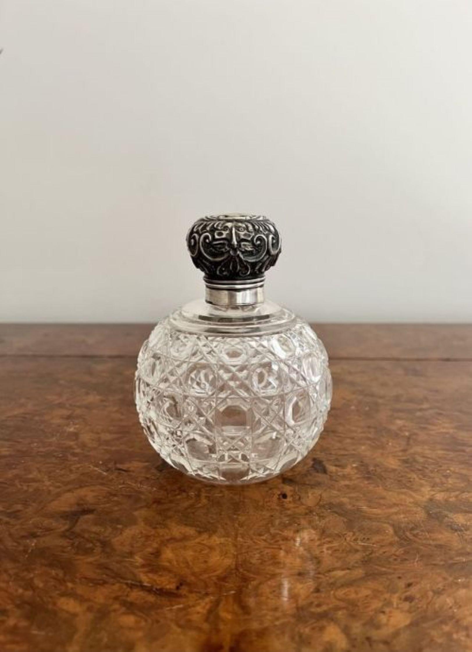 Quality antique Victorian Silver mounted scent bottle having a quality antique Victorian silver mounted scent bottle with a cut glass circular body and an ornate silver top.