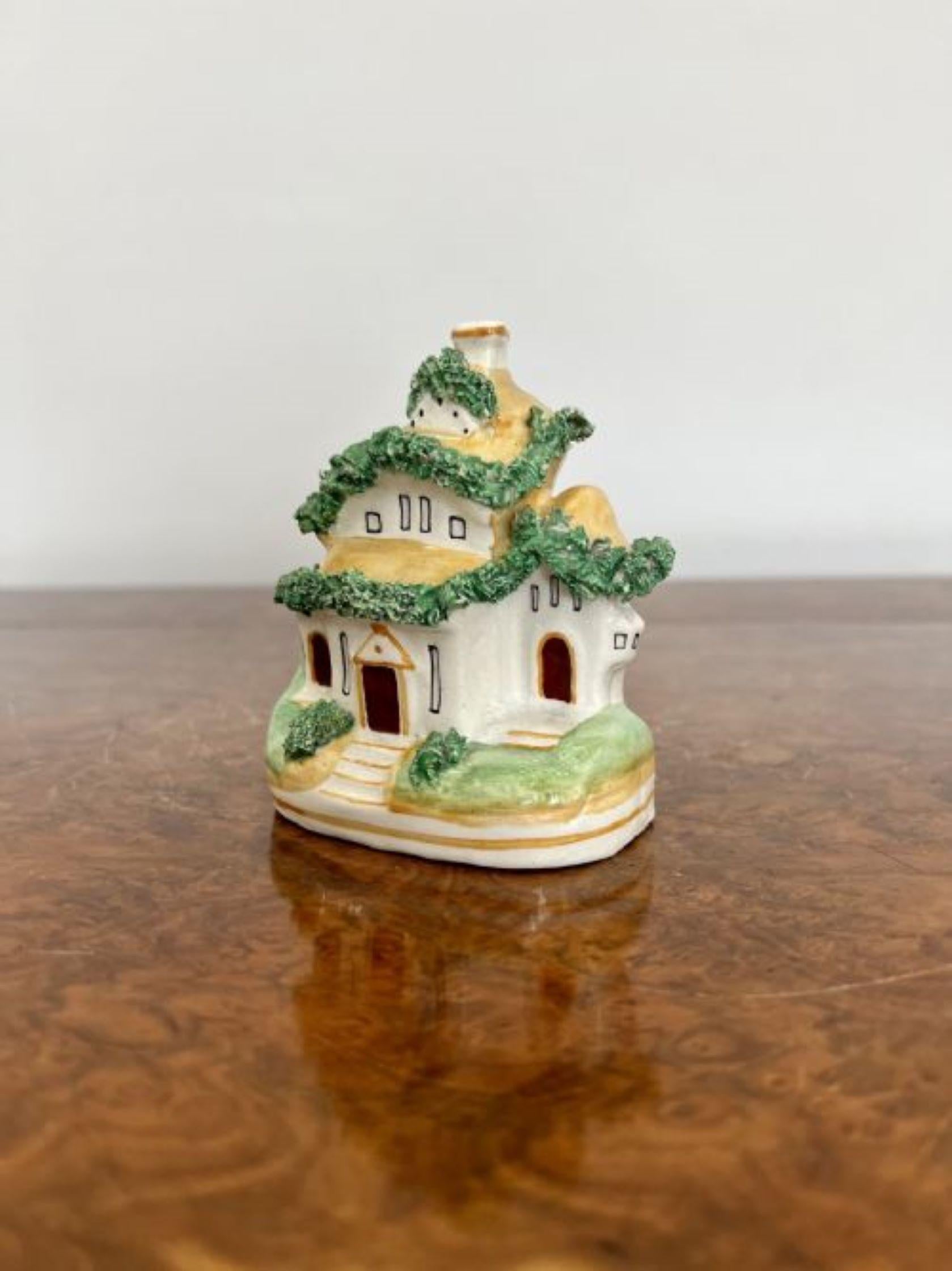 Quality antique Victorian Staffordshire cottage having a lovely model of a cottage with vibrant green foliage in wonderful green, white, yellow and brown colours 