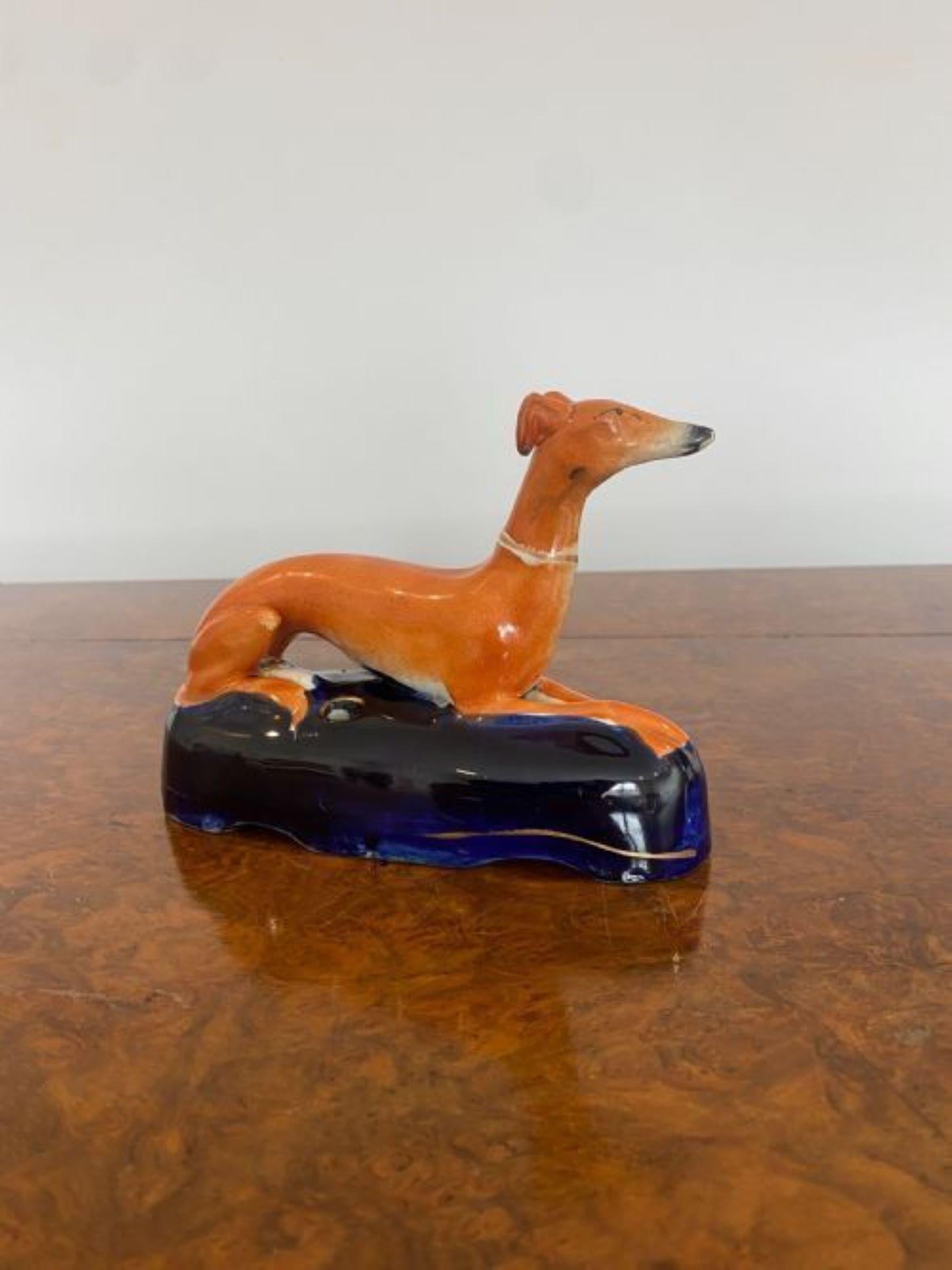 Quality antique Victorian Staffordshire Greyhound laying on a shaped blue coloured base, hand painted in wonderful blue and brown colours