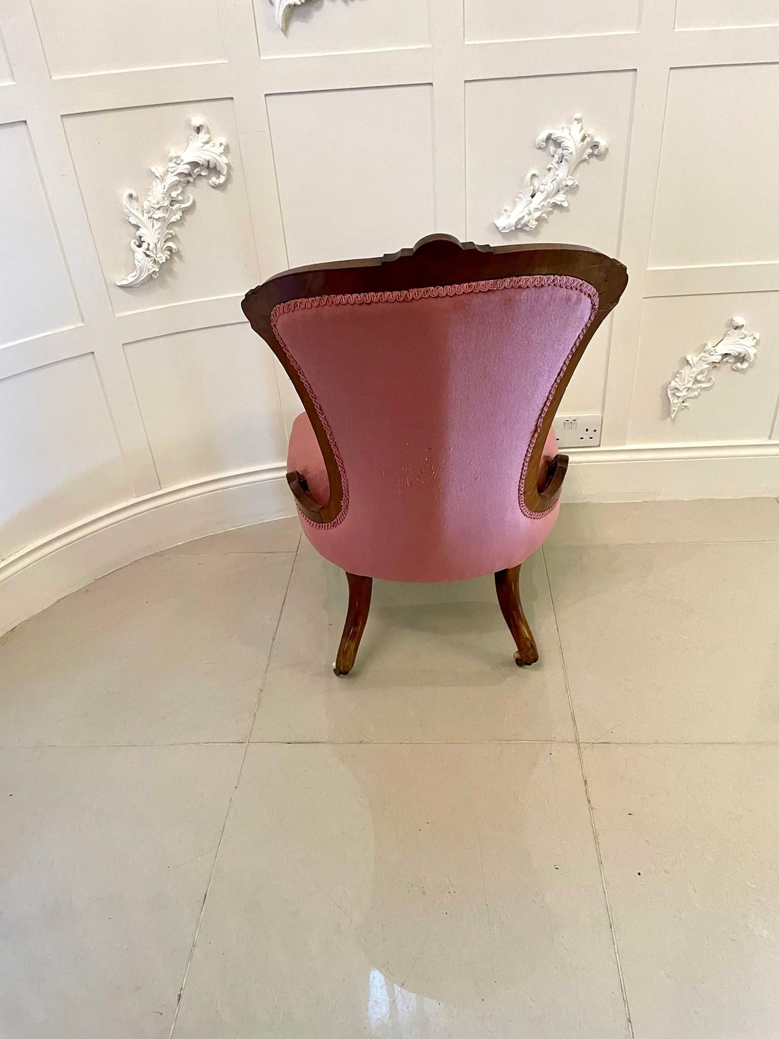 Quality Antique Victorian walnut ladies chair having a quality shaped carved back and raised on solid walnut turned reeded legs to the front and out swept back legs on original porcelain castors. Upholstered in a pink fabric. 

H 90cm 
W 55.5cm