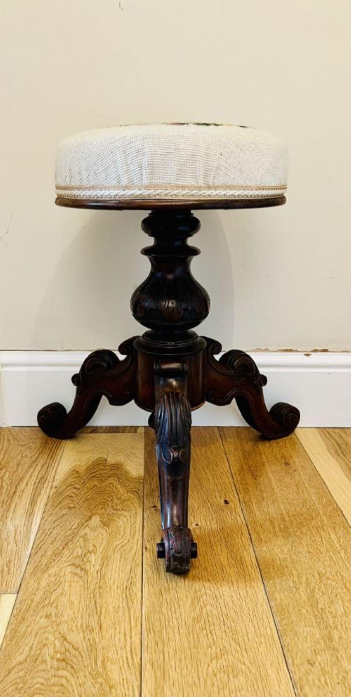 Quality antique Victorian walnut revolving piano stool having a circular revolving needlepoint tapestry seat supported on a shaped reeded column raised on three shaped carved walnut cabriole legs with scroll feet