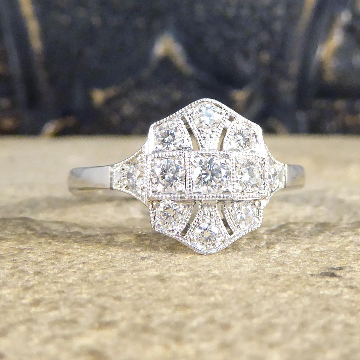 This gorgeous ring has been hand crafted and is new and never worn. It has been designed and carefully crafted to resemble an Art Deco style ring with such a quality feel to it. This ring is set with an array of Brilliant Cut Diamonds all