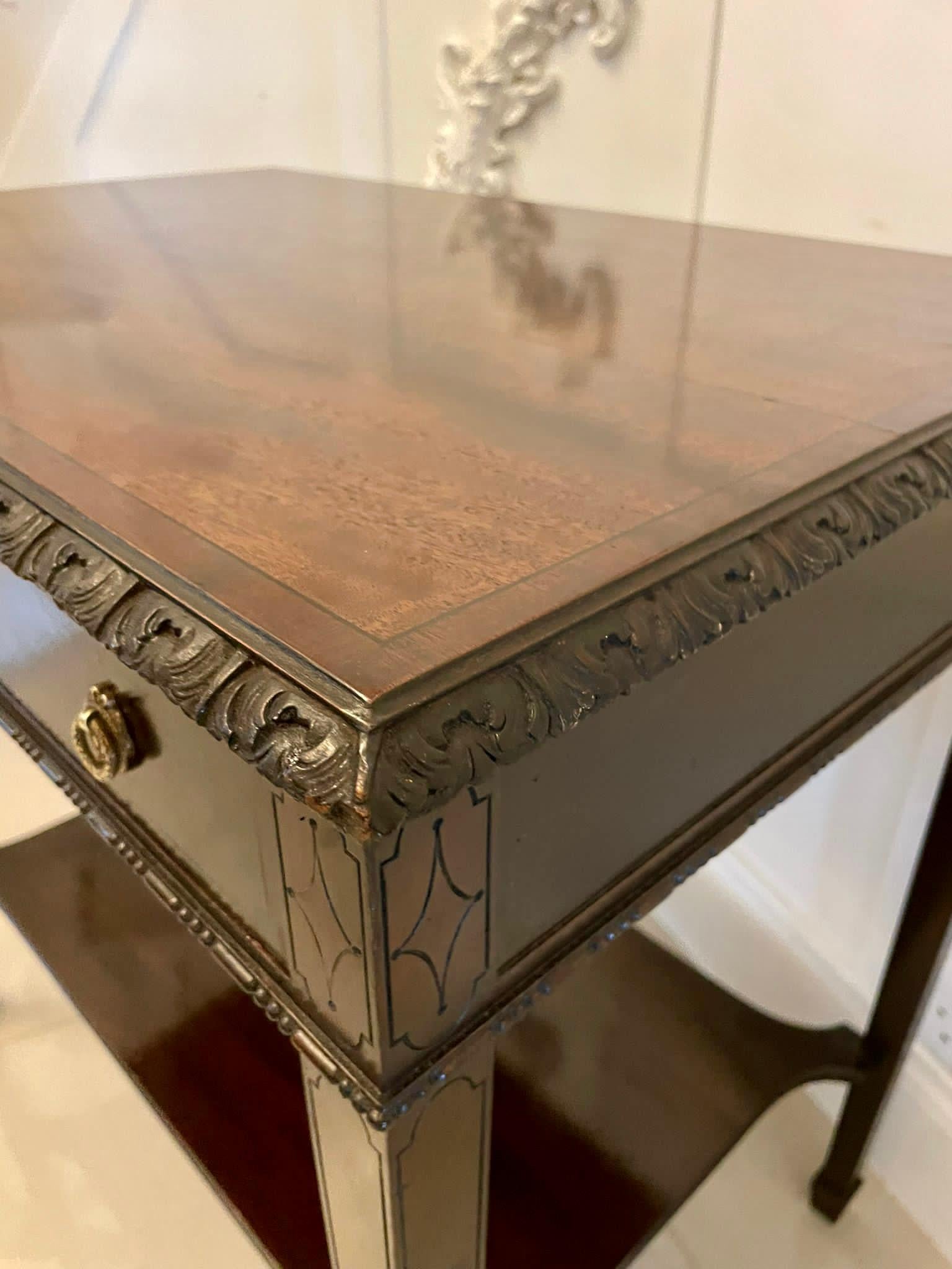 Quality Edwardian mahogany free standing side/lamp table having a glorious mahogany top with a quality carved edge, two frieze drawers with original brass handles standing on four elegant square tapering legs with spade feet united by a shaped