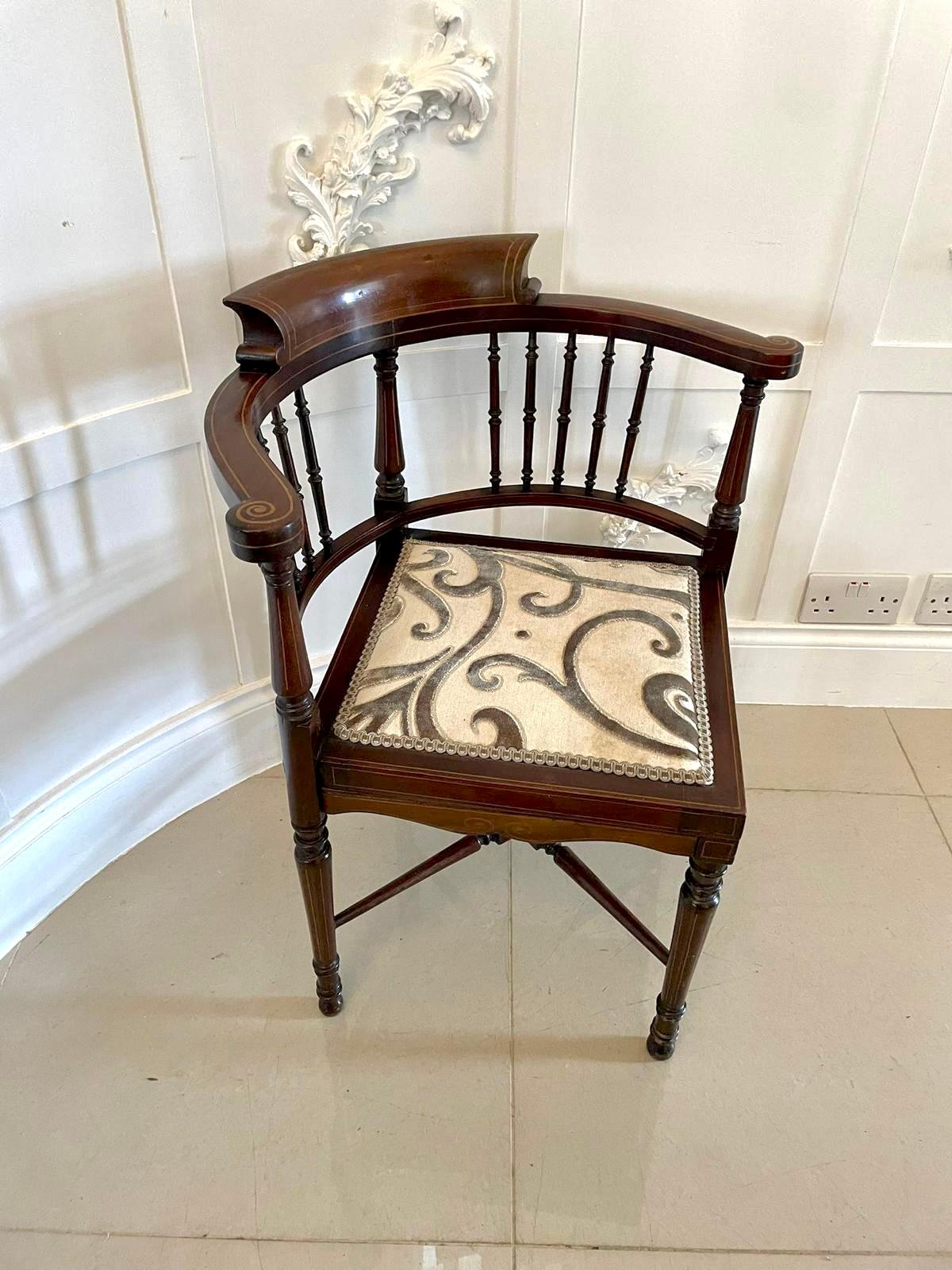 Quality Edwardian mahogany inlaid corner chair having a lovely quality shaped back with attractive satinwood inlay, newly recovered seat and standing on turned tapering legs united by a turned cross stretcher

A charming chair boasting a