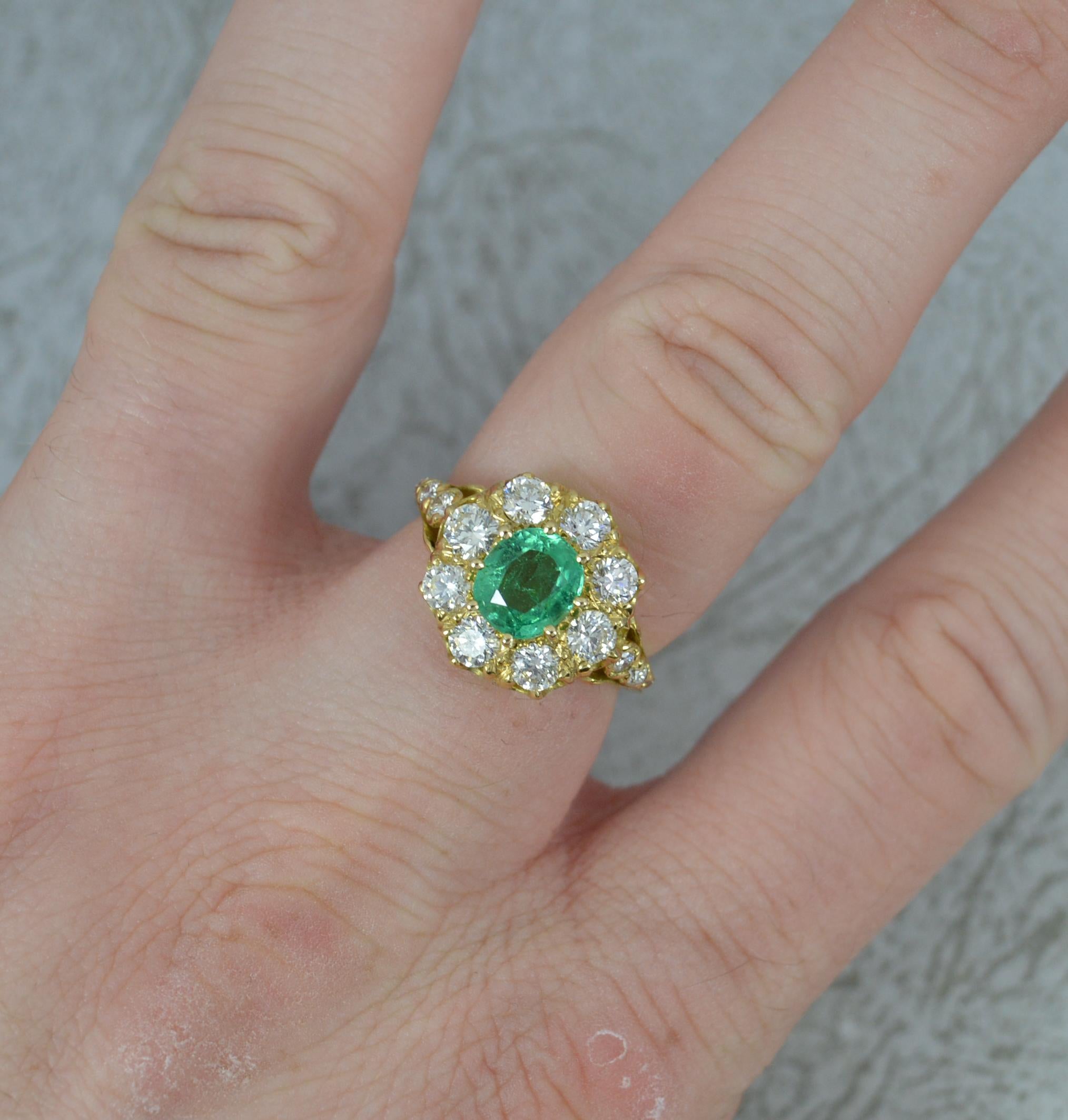 A stunning Emerald and Diamond ring.
Modelled in 18 carat yellow gold throughout.
Designed with a natural emerald to centre in an eight claw setting. 6.1mm x 7.0mm. A superb colour and hue. Surrounding are eight natural, round brilliant cut