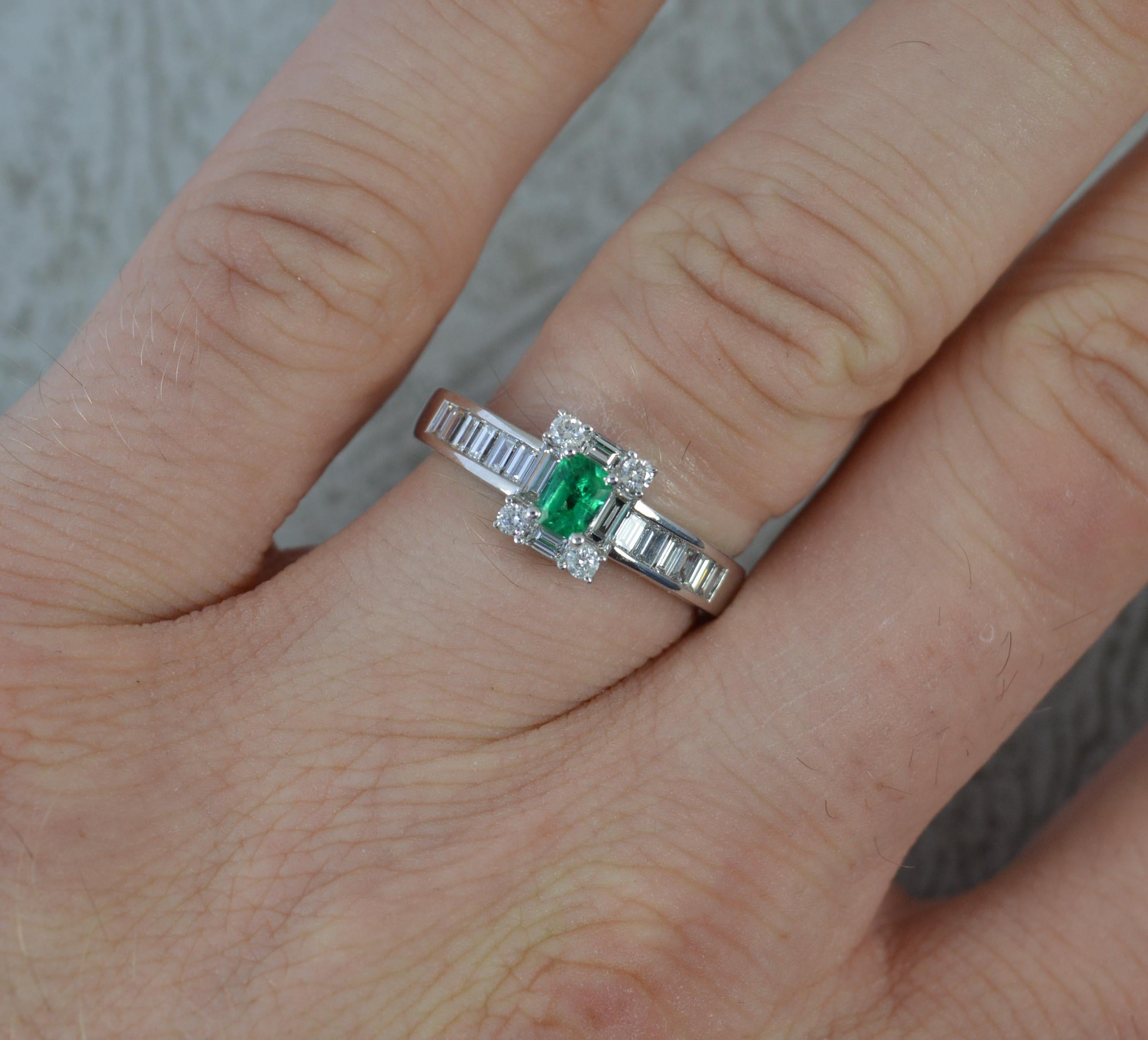 A stunning Emerald and Diamond cluster ring.
Modelled in an 18ct white gold example.
Designed with an emerald cut emerald to centre in four claw setting. Clean and vibrant. Surrounding are four emerald and four round brilliant cut diamonds creating