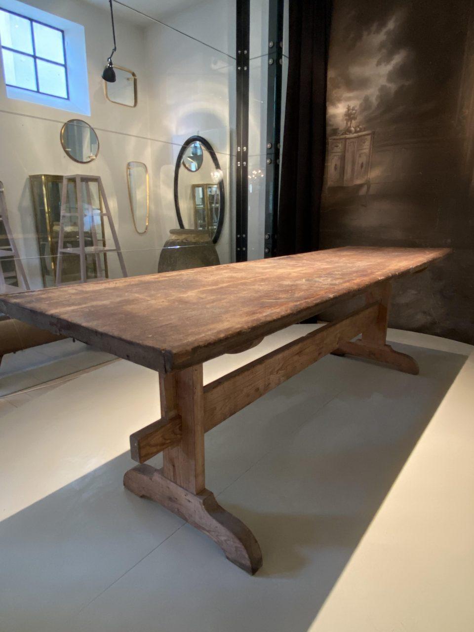 Wonderful antique French long table, in a solid oak tabletop and with a wooden base, late 19th century. Originally used as a work table by a jeweler, and has fantastic authentic patina as well as two charming tin repairs on the table surface.

An