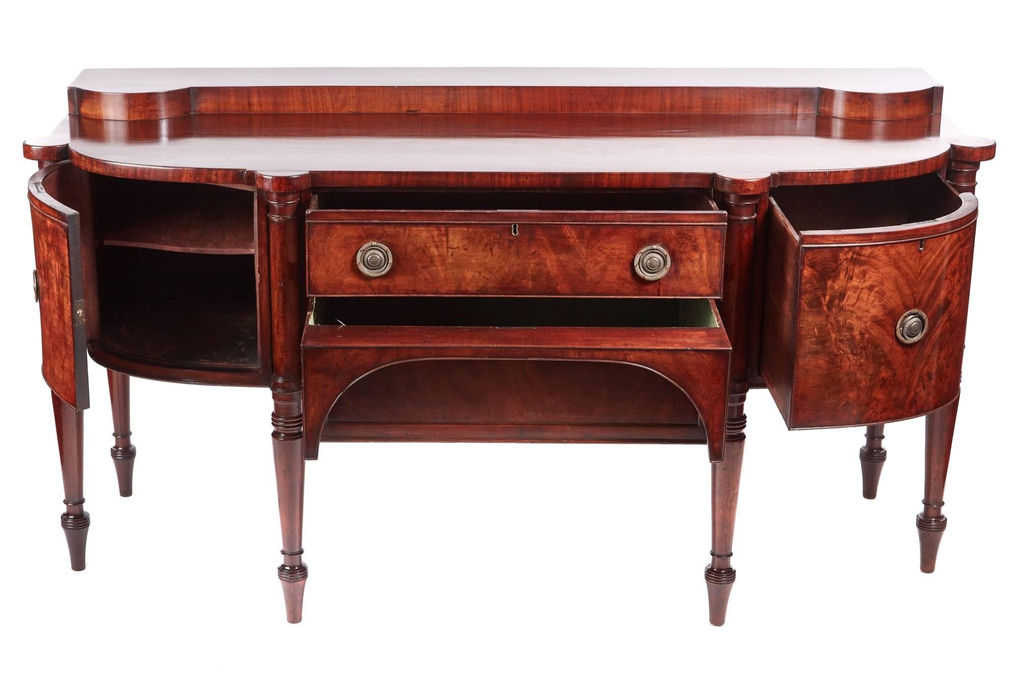 Quality George III antique mahogany sideboard, having a low shaped gallery with a fantastic mahogany top, two long cutlery drawers to the front flanked either side by a single wine drawer and a cupboard door all with original brass handles, standing