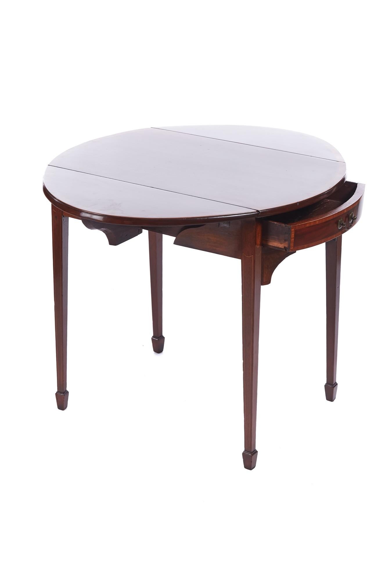 Quality Georgian inlaid mahogany Pembroke table having a lovely mahogany top cross banded in satin wood with 2 drop oval leaves. 1 frieze drawer 1 dummy drawer with original brass handles, standing on 4 square tapering legs with spade feet united by