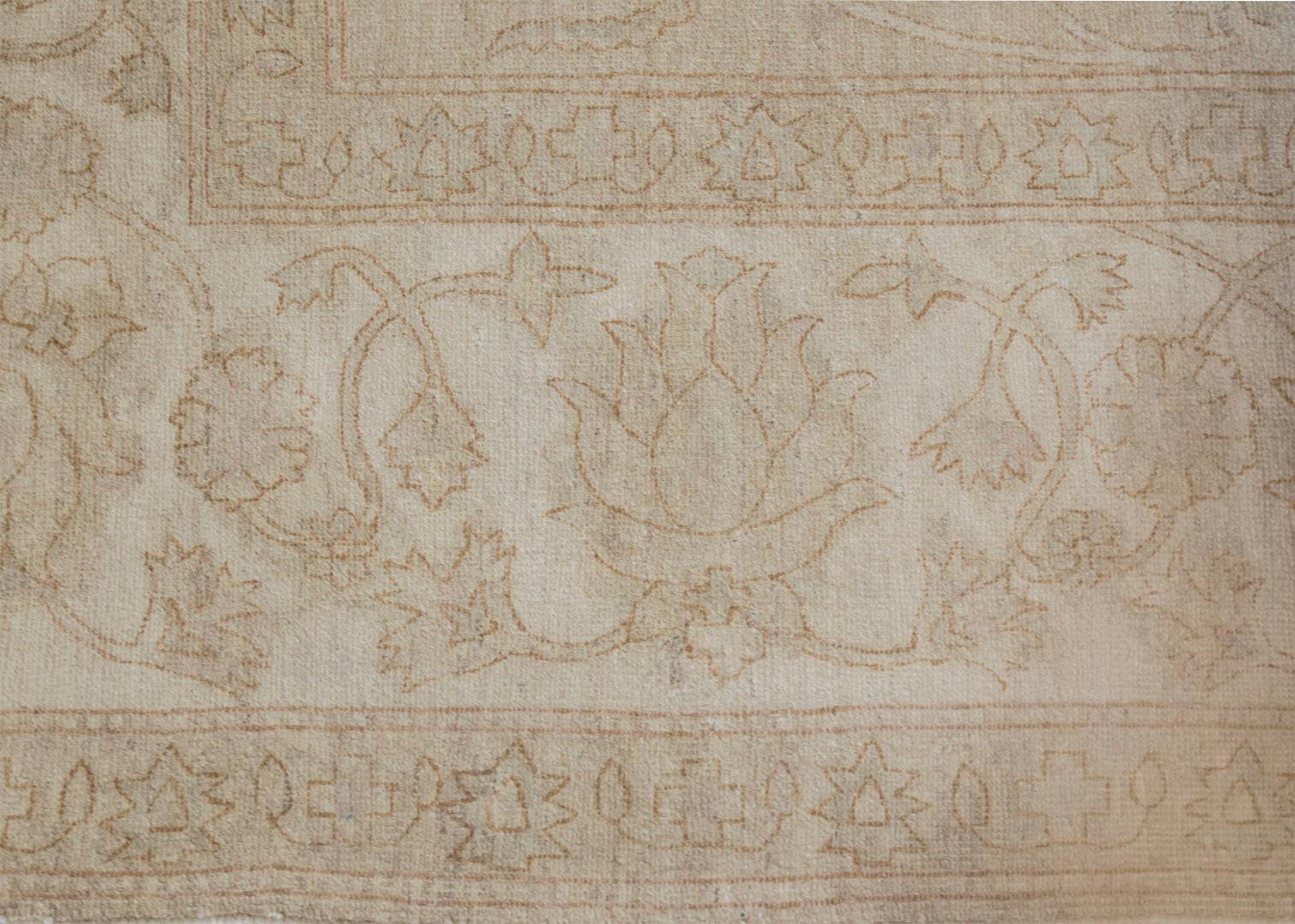 Handwoven in Kashmir, this high quality Agra-inspired rug features a masterful color combination and a decorative design. 100% natural wool pile. Brand new.