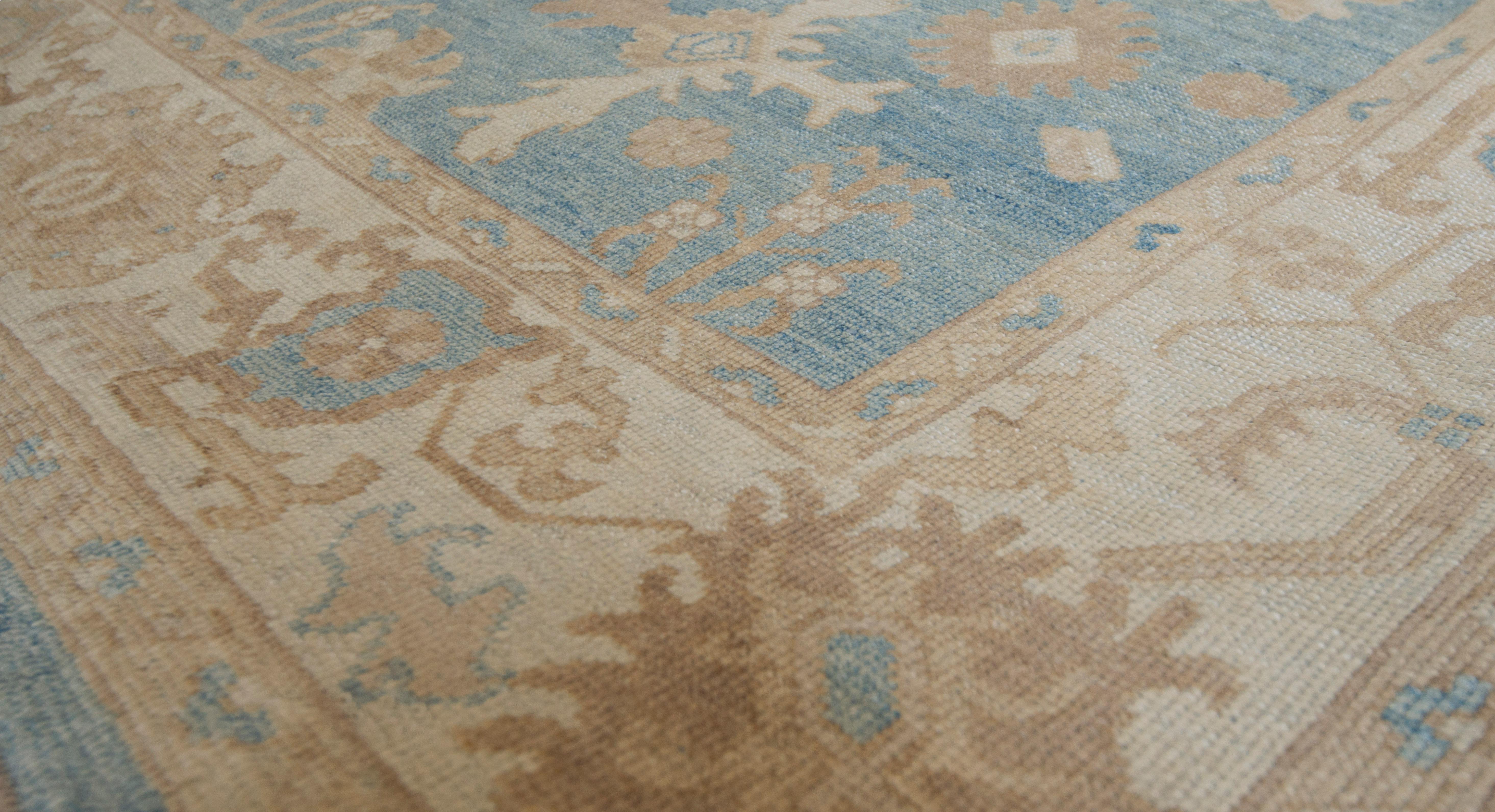 Created in Turkey, this superb quality Oushak features a soothing blue color field and decorative large scale all-over patterns. 100% natural wool pile. Brand new.
