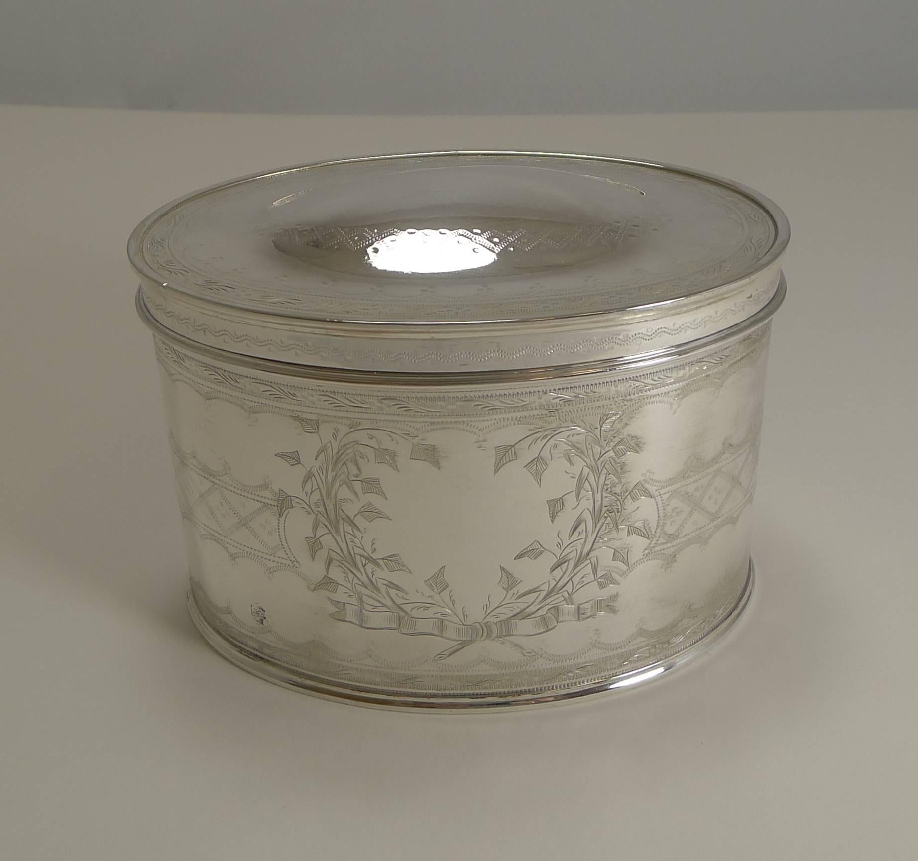 A wonderful quality late Victorian / early Edwardian tea caddy made from silver plate and dating to circa 1900.

The oval caddy has a hinged lid incorporating a central dome. The caddy has been meticulously decorated with intricate engraving