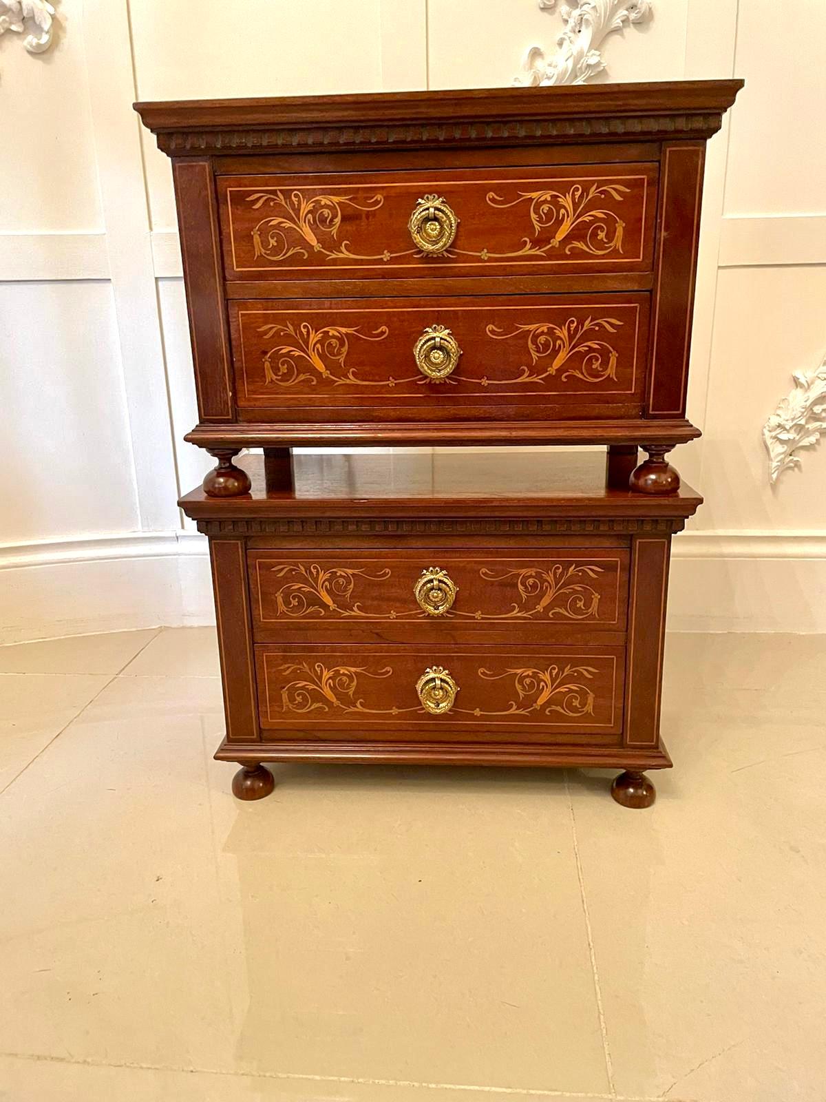 Quality pair of antique Edwardian inlaid mahogany chests having splendid mahogany tops with a moulded edge, two pretty marquetry inlaid drawers with attractive original ornate brass handles and raised on turned mahogany bun feet.

A fine pair