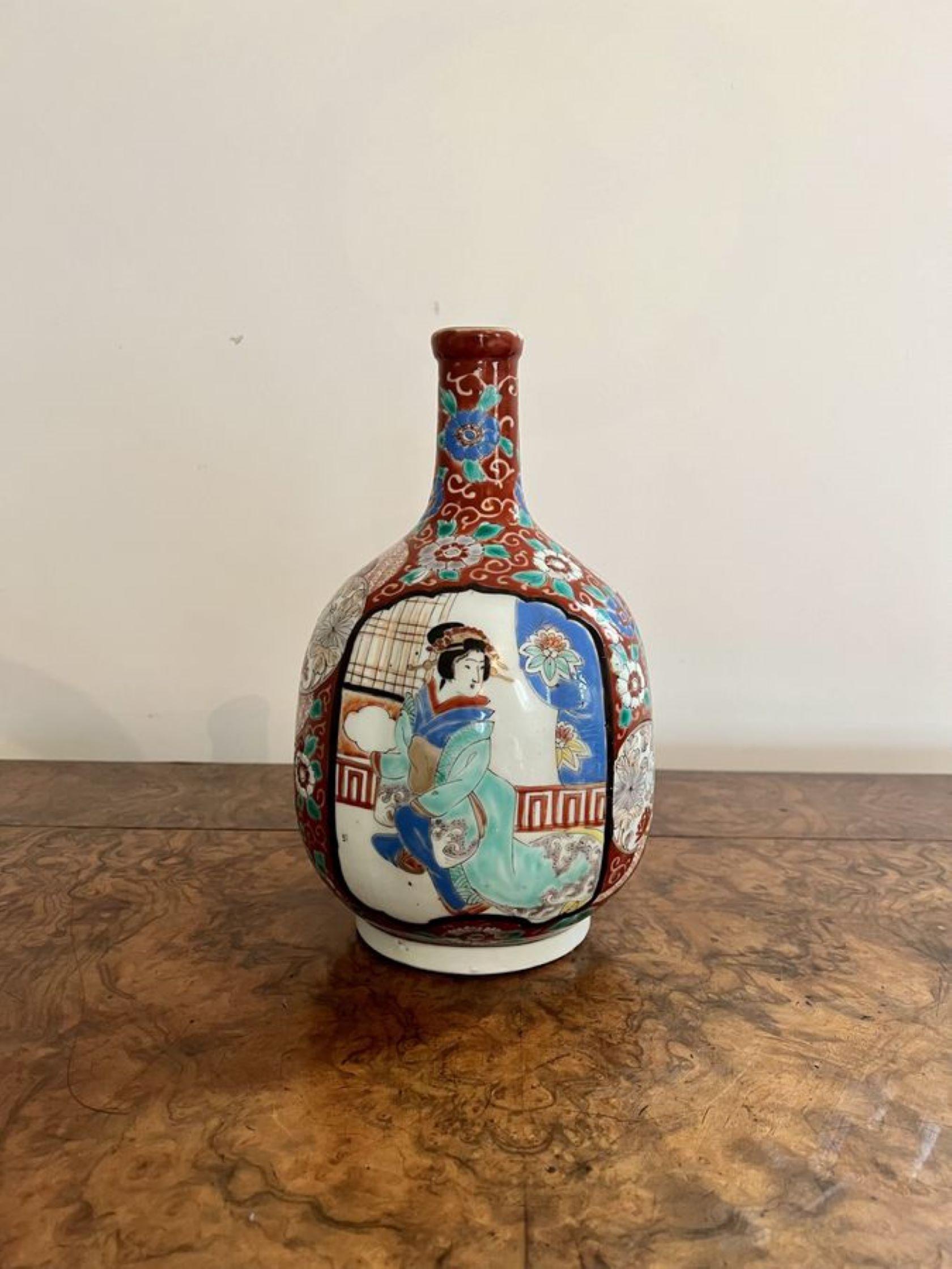 Quality pair of antique Japanese imari shaped vases, having a quality pair of antique Japanese porcelain vases, having a slender neck above a bulbous body, enamel decorated with Samurai within a cartouche on red ground, decorated with flowers and
