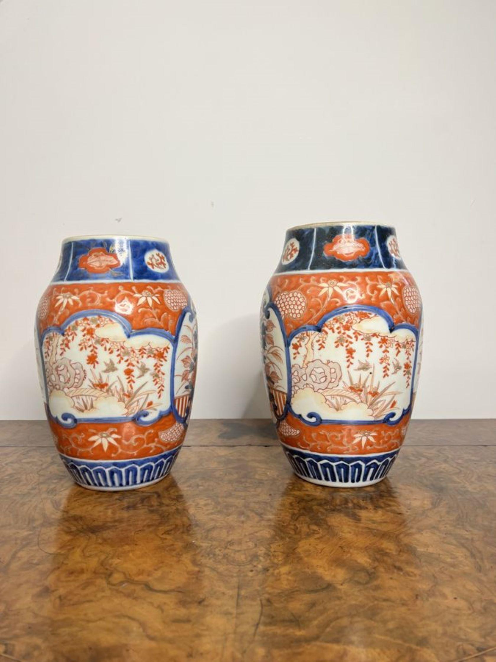 Quality pair of antique Japanese imari vases having a quality pair of shaped Japanese imari vases decorated with panels with flowers, leaves, trees, birds and patterns hand painted in wonderful red, blue and with colours. 

D. 1900