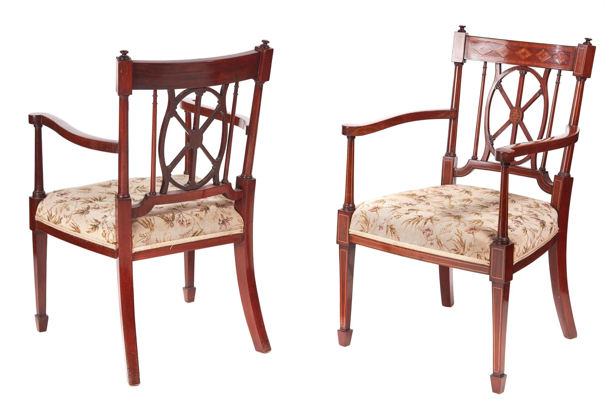 Quality pair of antique mahogany inlaid arm or desk chairs with fine inlaid satinwood tops and centre splat. They boast elegant shaped inlaid arms and are raised on inlaid square tapering front legs terminating in spade feet and outswept back