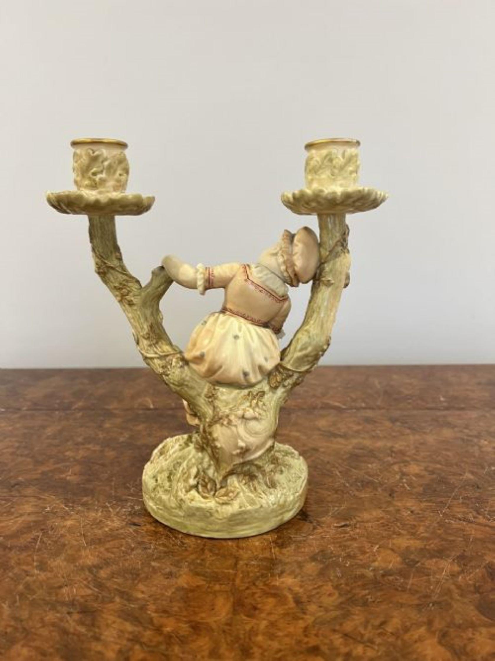 Quality pair of antique Royal Worcester Hadley candlesticks having a quality pair of candlesticks with figures modelled as children hand painted in wonderful green, pink, red and yellow colours leaning against branches with two candle sconces at the