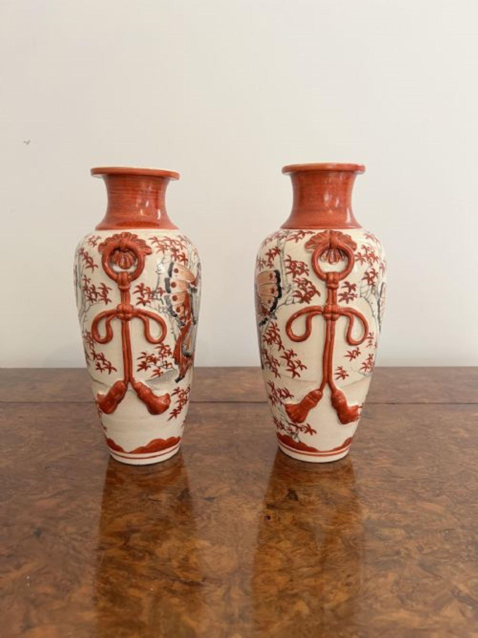 Quality pair of antique Satsuma vases having a quality pair of satsuma vases hand painted with wonderful decorated panels of traditional figures, leaves and trees in fantastic red, grey, black and white colours raised on circular bases.