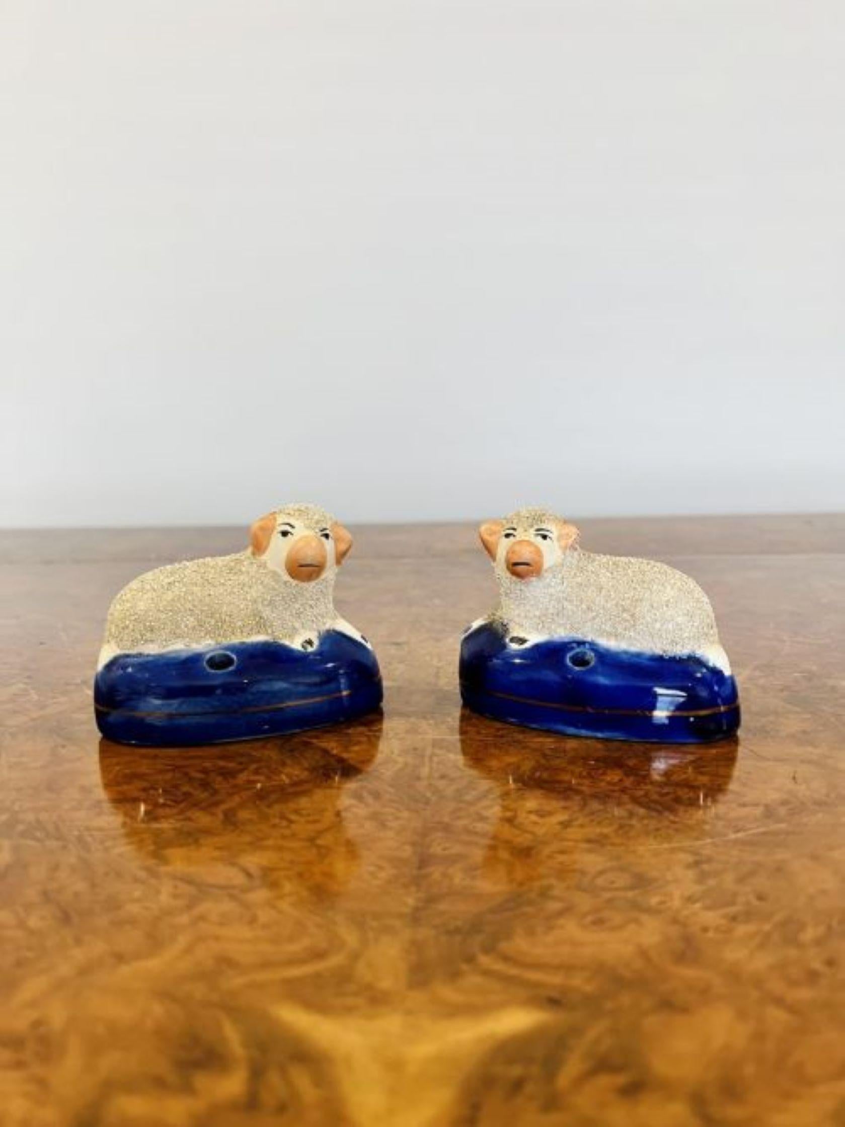 Quality pair of antique Staffordshire sheep ink wells having a quality pair of confetti glazed sheep ink wells  laying on a blue and gold base 