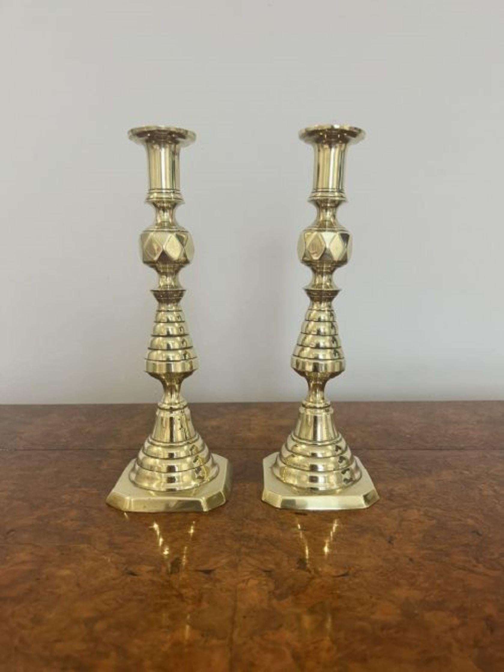 Quality pair of antique Victorian brass candlesticks having a quality pair of antique Victorian brass candlesticks with a turned shaped column standing on a stepped base. 