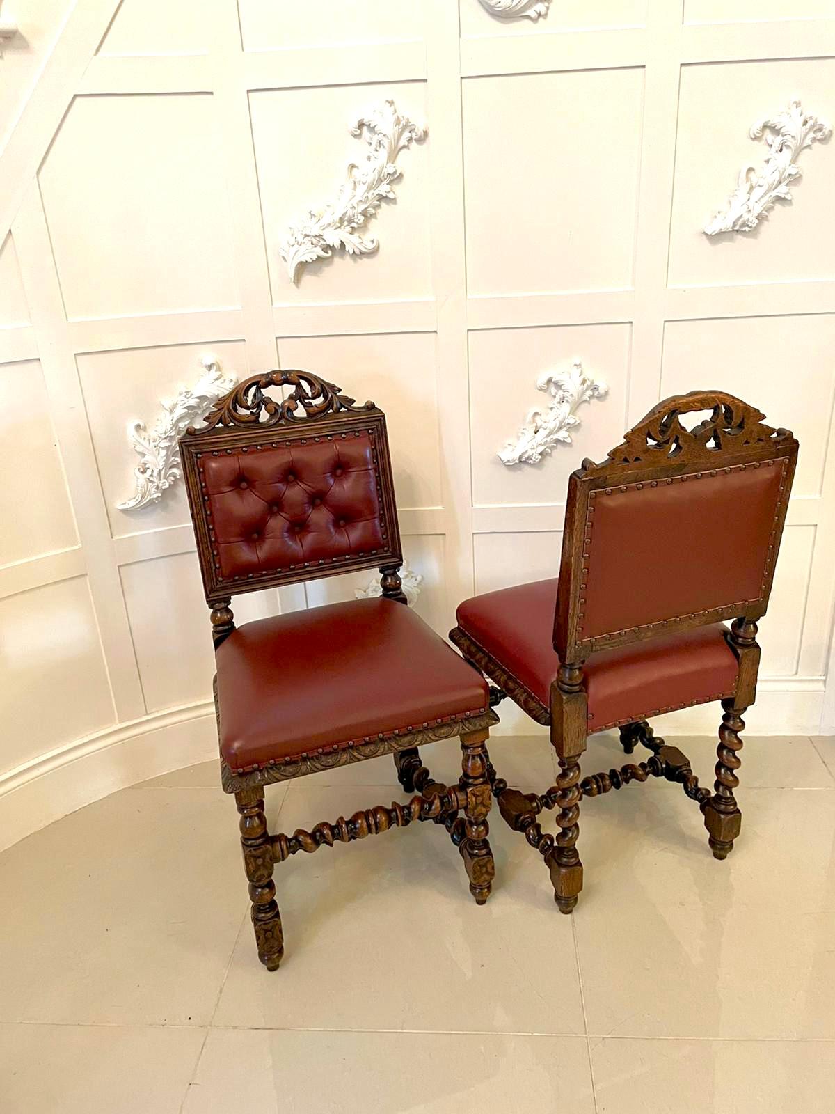 Quality pair of four antique Victorian carved oak side/desk chairs having a quality carved oak top rail above a moulded panel with newly reupholstered buttoned backs and seats in burgundy leather. They boast a marvelous carved frieze and stand on