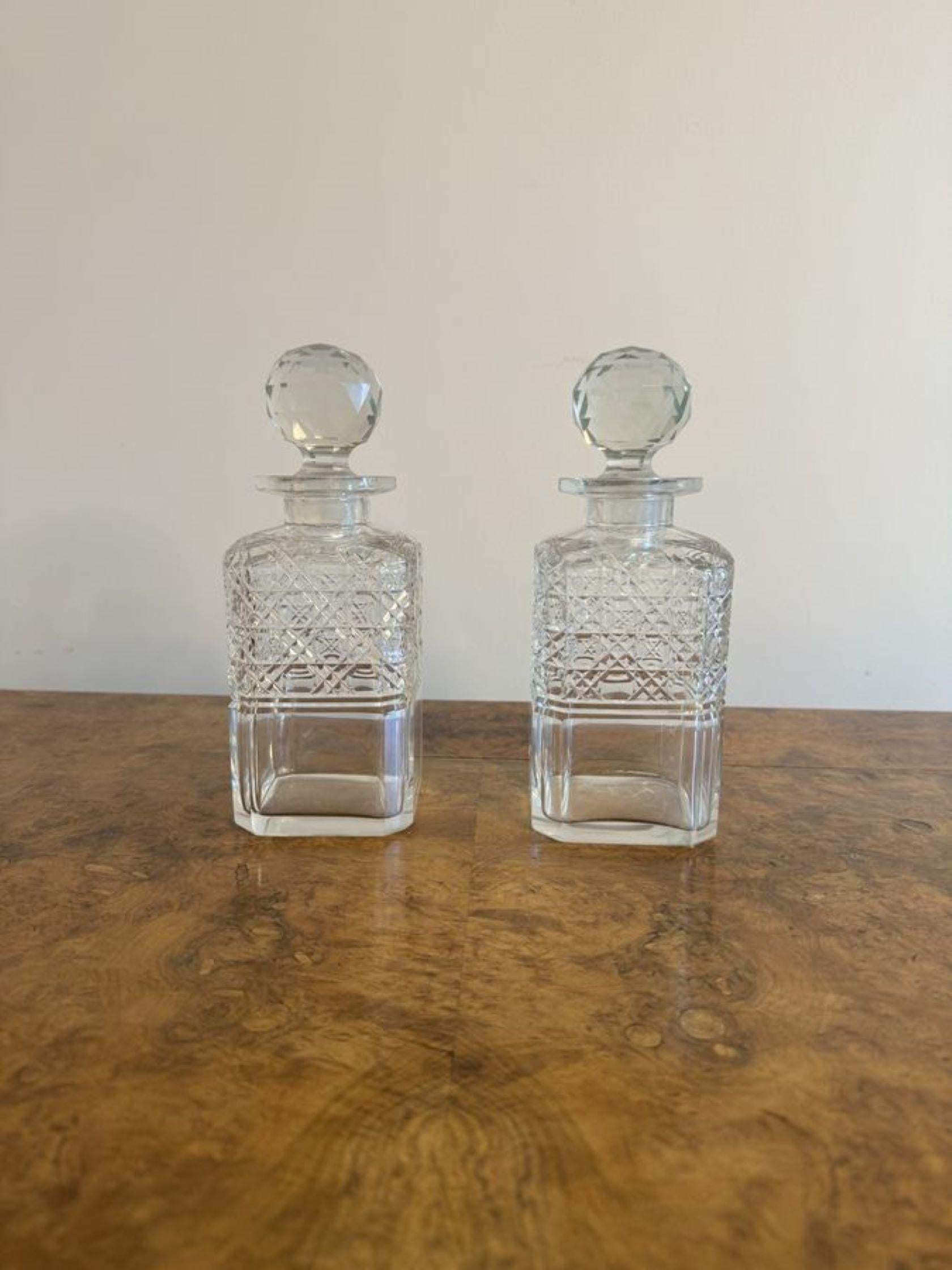 Quality pair of antique Victorian cut glass decanters having a quality pair of antique Victorian cut glass decanters with square shaped cut glass bodies and cut glass stoppers.

D. 1880