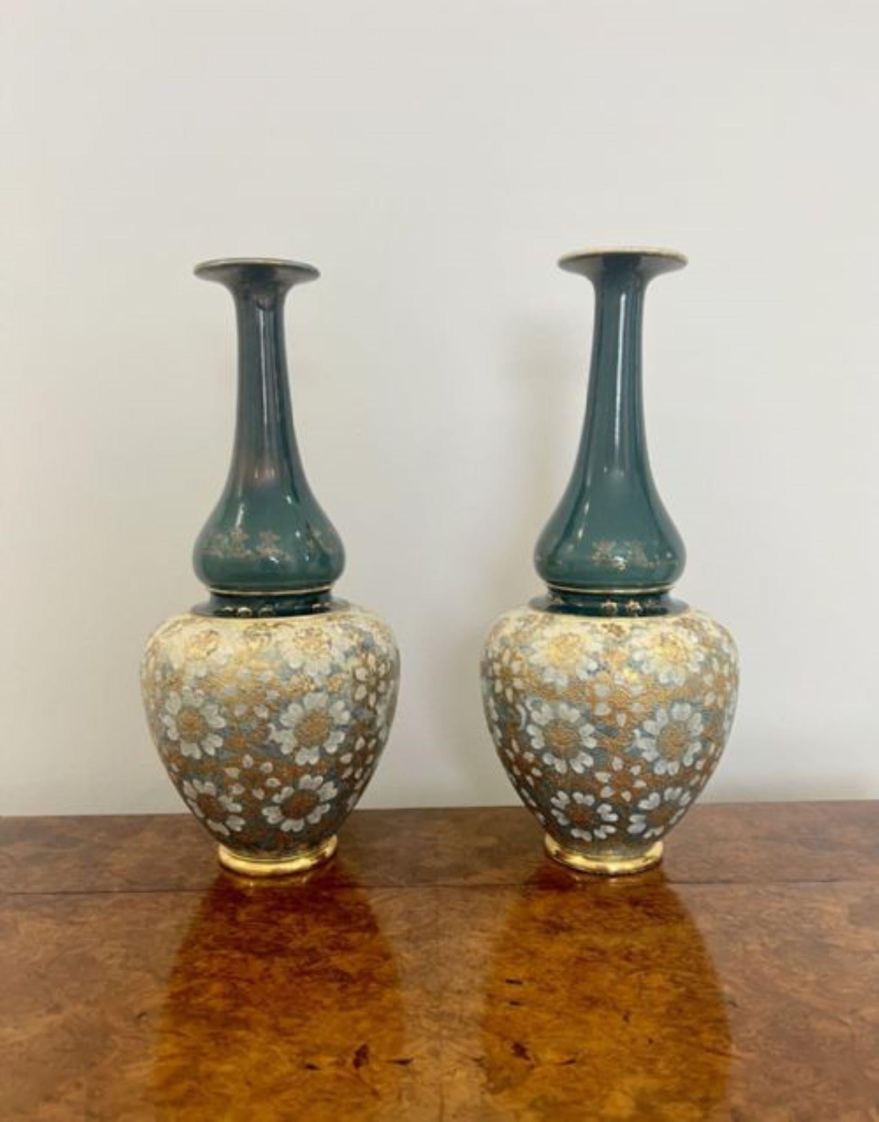 Quality pair of antique Victorian large ballister Royal Doulton vases having a quality pair of antique Royal Doulton shaped vases in wonderful green, gold and white colours with flower decoration standing on circular gilded bases. Markings to the