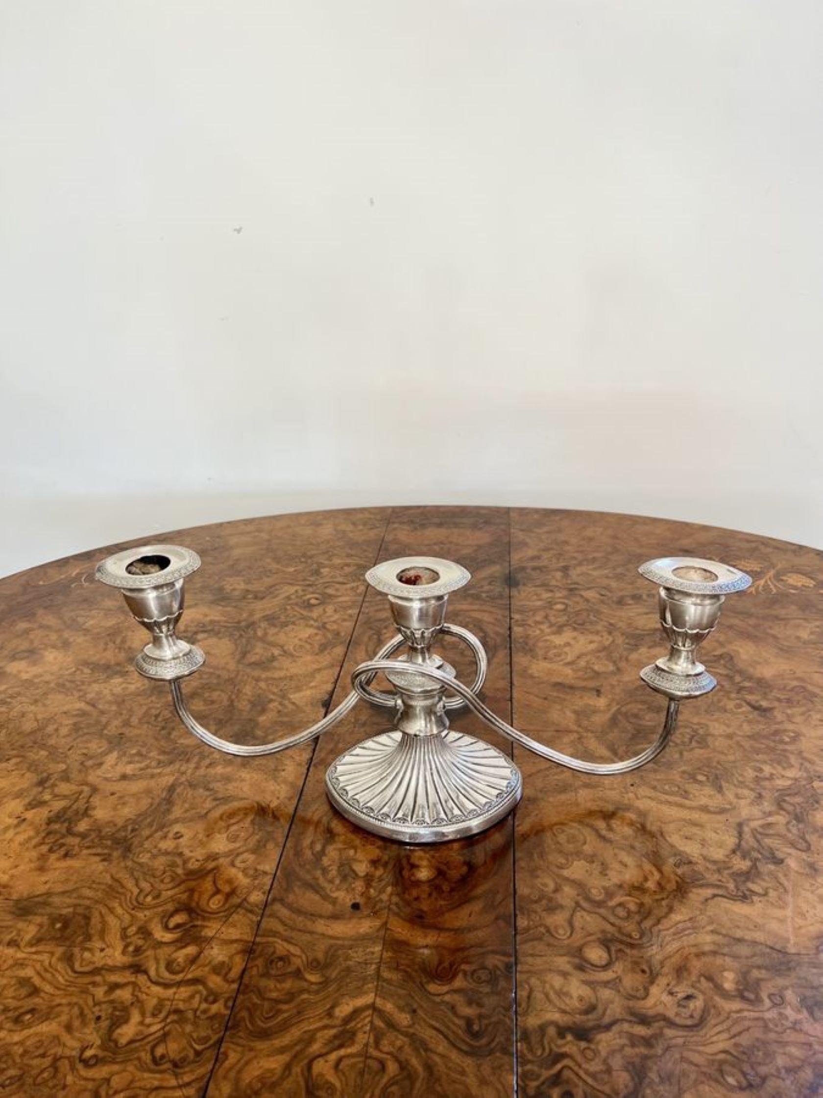 Quality pair of antique Victorian silver plated candelabras having a quality pair of antique Victorian candelabras with three light branches above a shaped column raised on ornate silver plated oval bases.

D. 1880