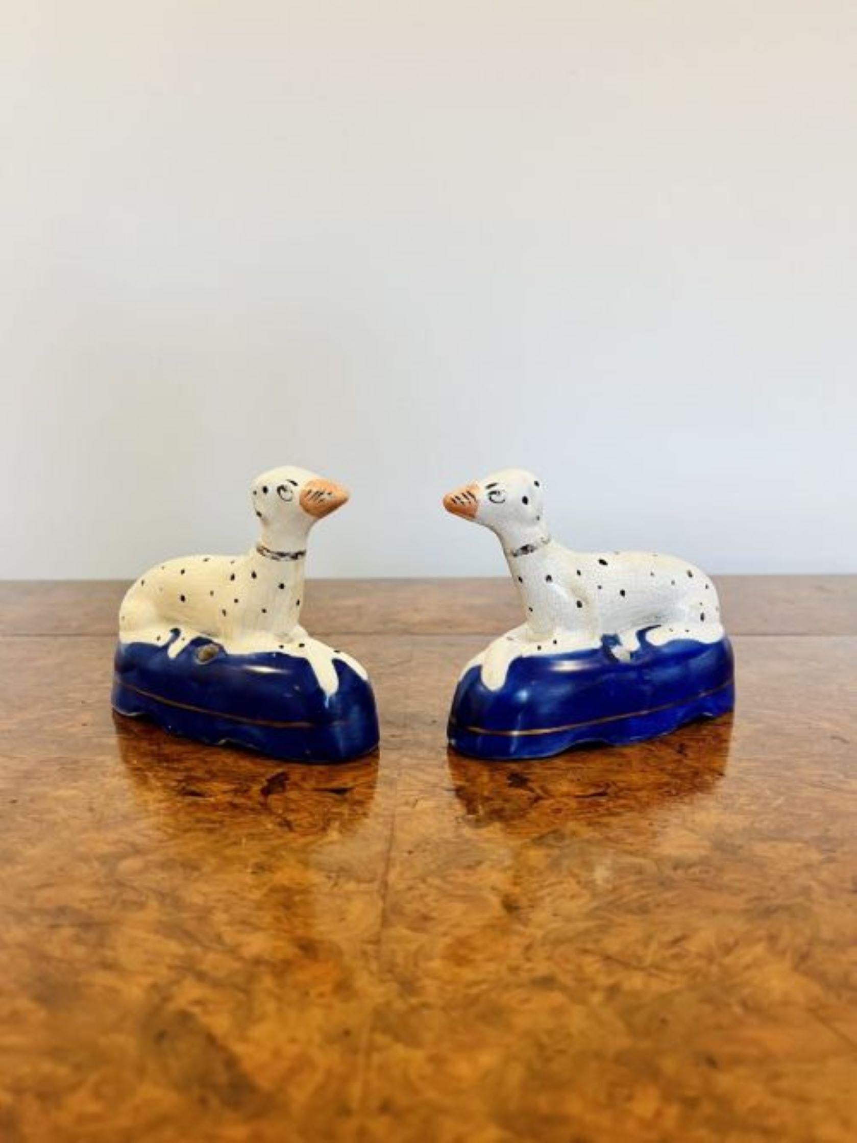 Quality pair of antique Victorian Staffordshire Dalmatian inkwells having a quality pair of Dalmatians laying down on a blue shaped base hand painted with white coats and black spots. 