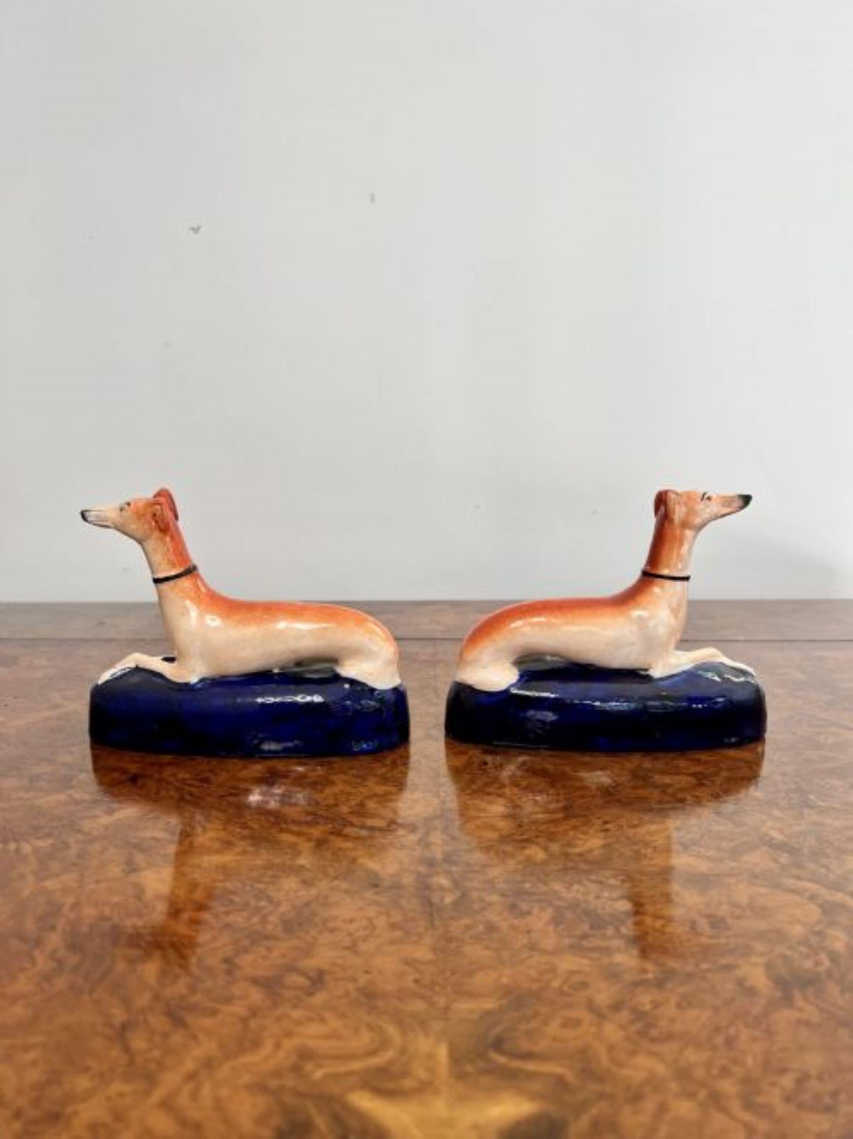 Quality pair of antique Victorian Staffordshire greyhound inkwells having a pair of greyhounds laying down on a blue shaped base hand painted in wonderful in brown, orange, blue and gold colours.