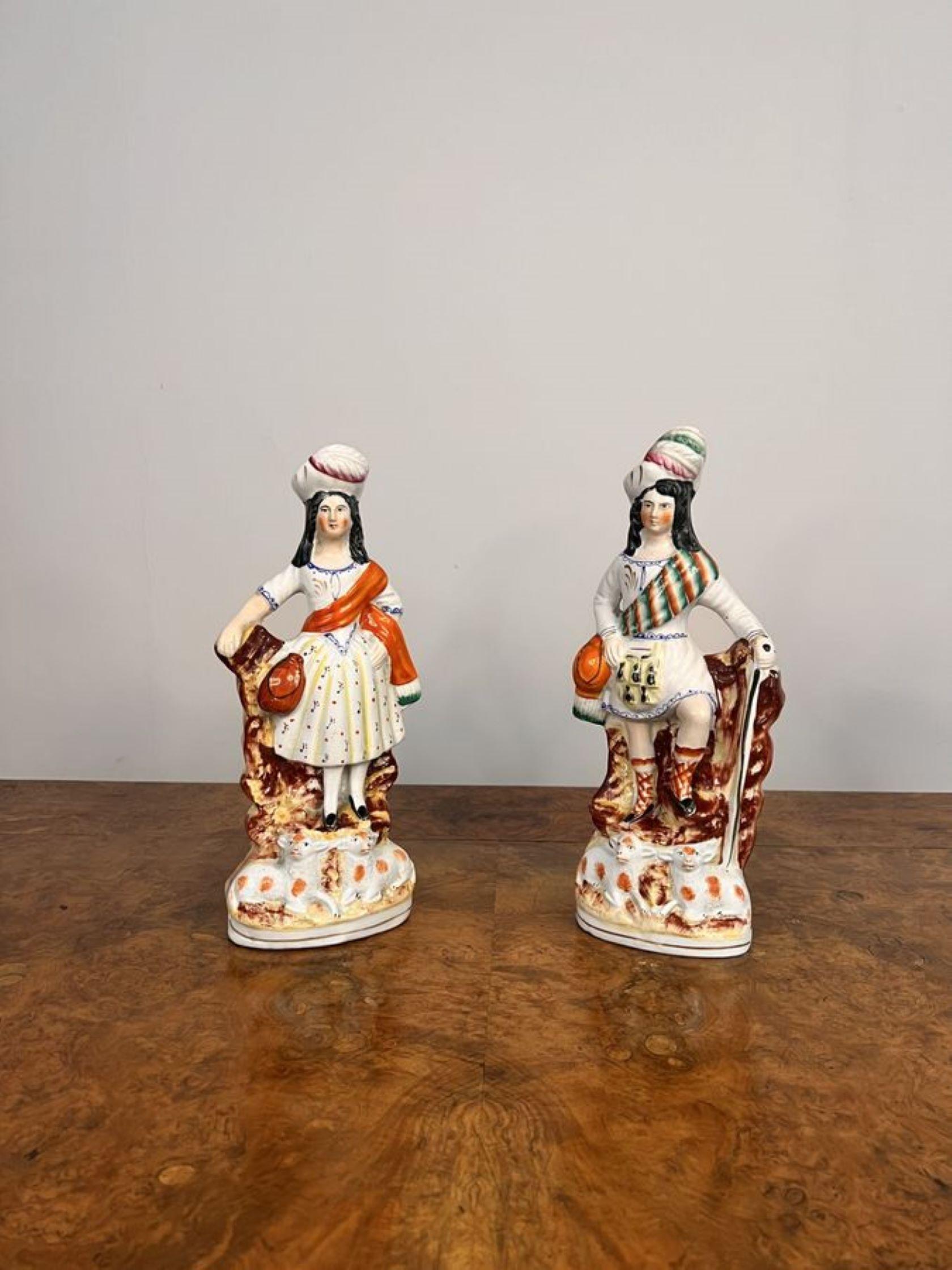 Quality pair of antique Victorian Staffordshire highland figures having a quality pair of antique Victorian staffordshire highland figures in traditional clothing hand painted in wonderful green, brown, pink and white colours standing above two