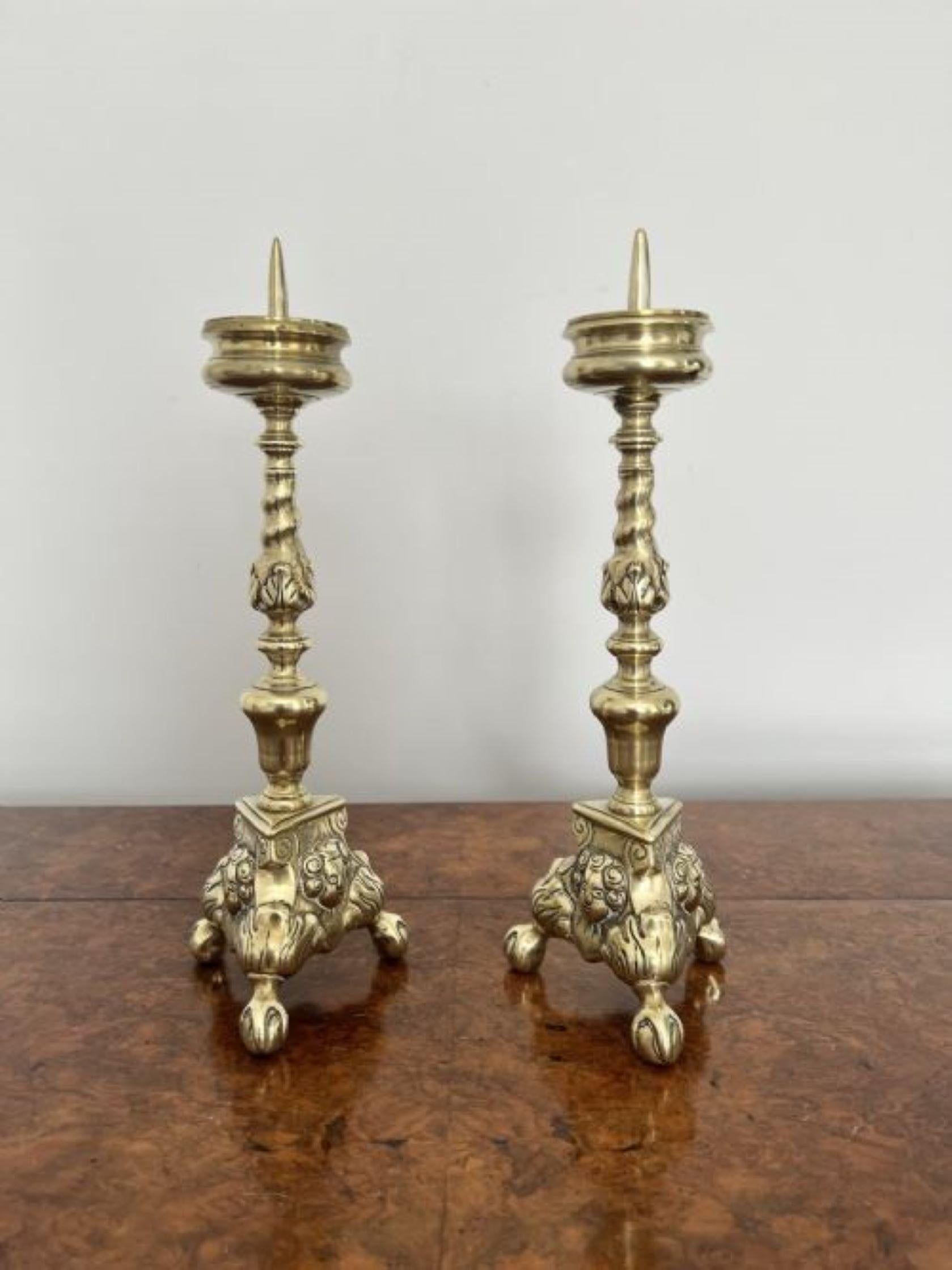 Quality pair of unusual antique Victorian ornate brass pricket candlestick having a quality unusual pair of ornate brass pricket candlesticks having a turned twisted stem above a tripod base standing on ball and claw feet