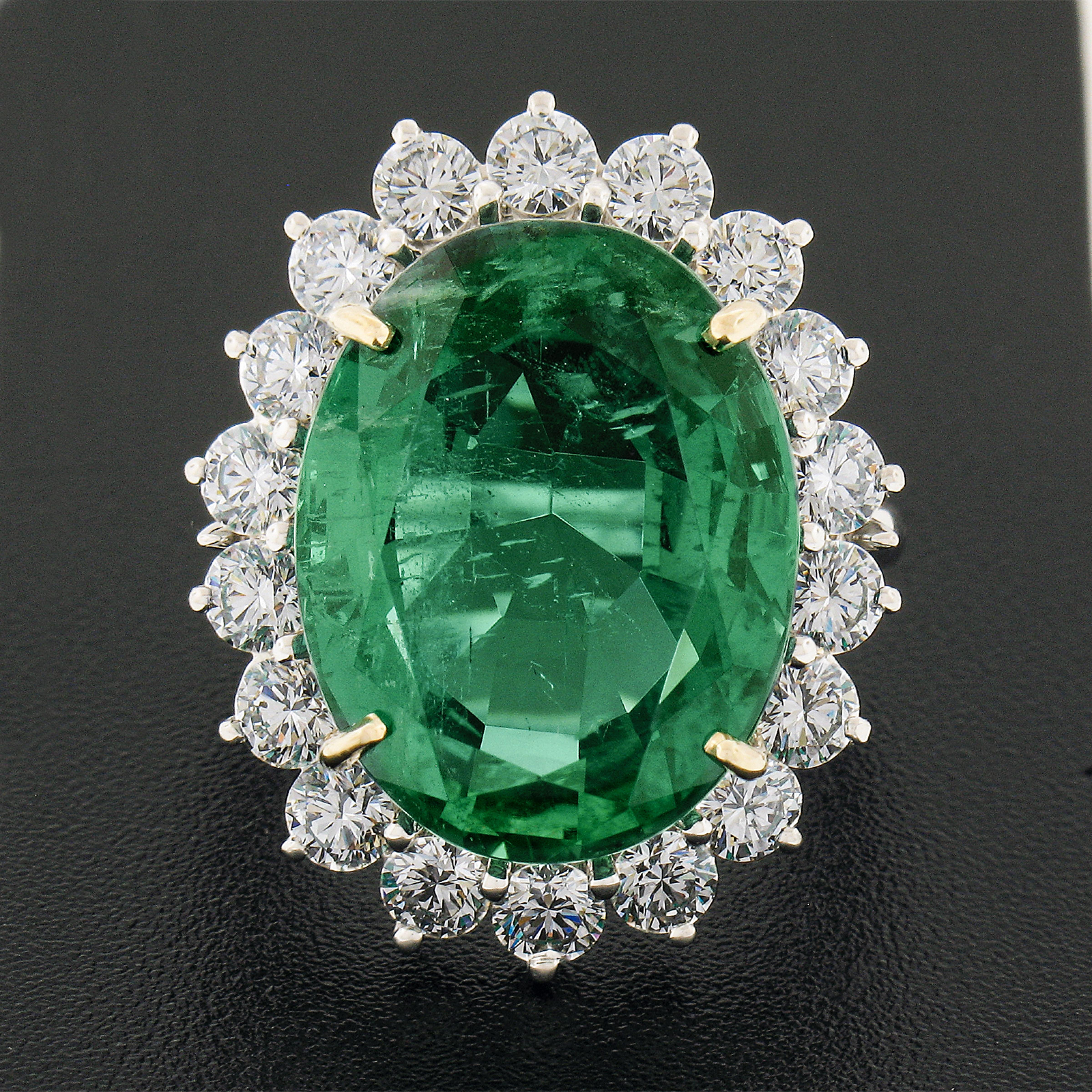 You are looking at a magnificent and truly jaw dropping emerald and diamond fancy cocktail statement ring crafted in solid platinum, featuring a large, oval cut, genuine emerald stone neatly prong set in solid 18k yellow gold at the center of the
