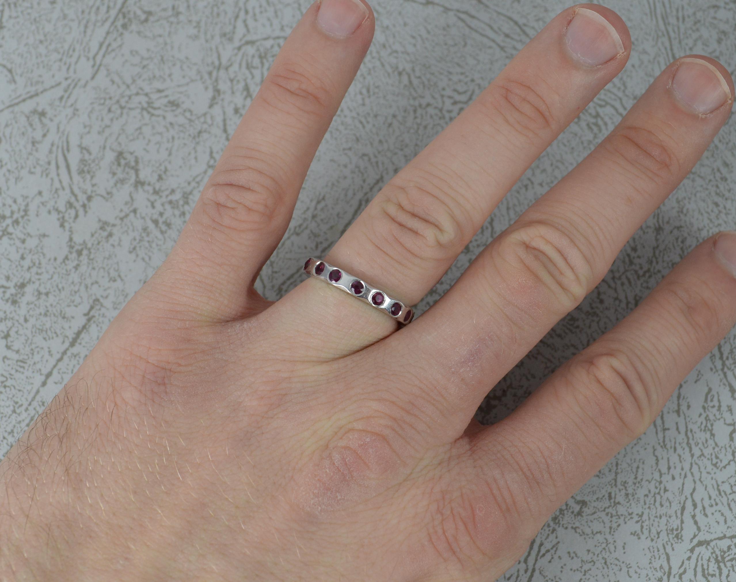 A stunning handmade platinum and ruby ring.
A full eternity design comprising of fifteen rich, pigeon blood red ruby stones.
3mm wide band throughout.

Condition; Excellent. Solid, clean band. Well set stones. Issue free. Please view