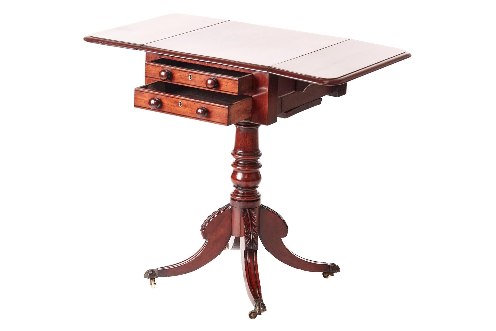 Quality Regency mahogany drop leaf lamp table, having a lovely quality mahogany top with two drop leaves, two drawers with original turned mahogany knobs, supported by a solid mahogany turned column, raised on four carved reeded sabred legs