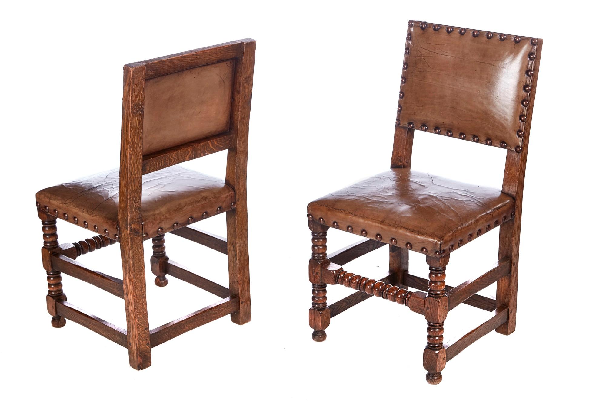 Quality set of 6 leather and oak dining chairs having lovely quality leather backs and seats with brass studs standing on bobbin turned legs to the front, outswept back legs united by bobbin turned stretcher.
Lovely color and condition.
Carver