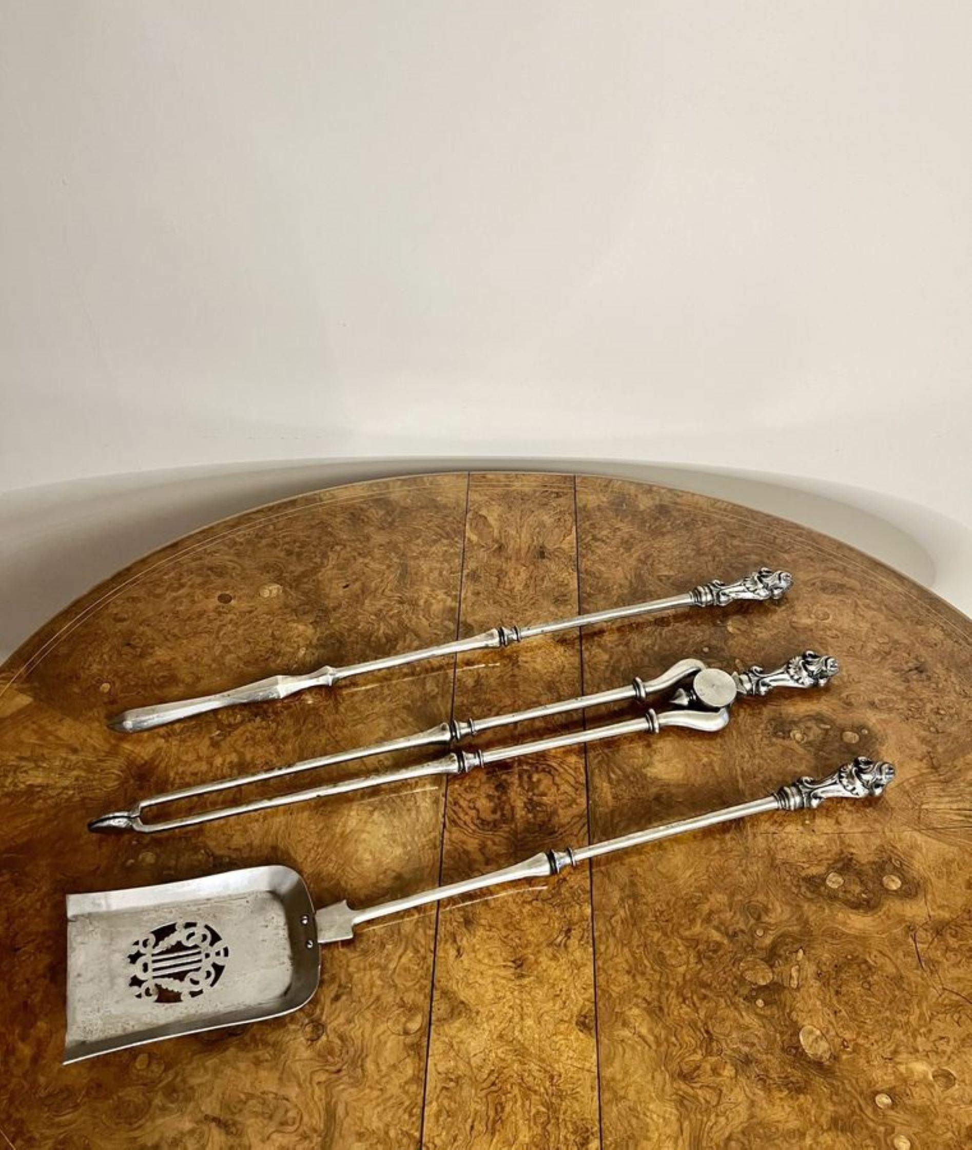 Quality set of antique George III steels fire irons having a quality set o fire irons consisting of a shovel, poker and a set of tongs with quality ornate detailed handles.

D. 1800