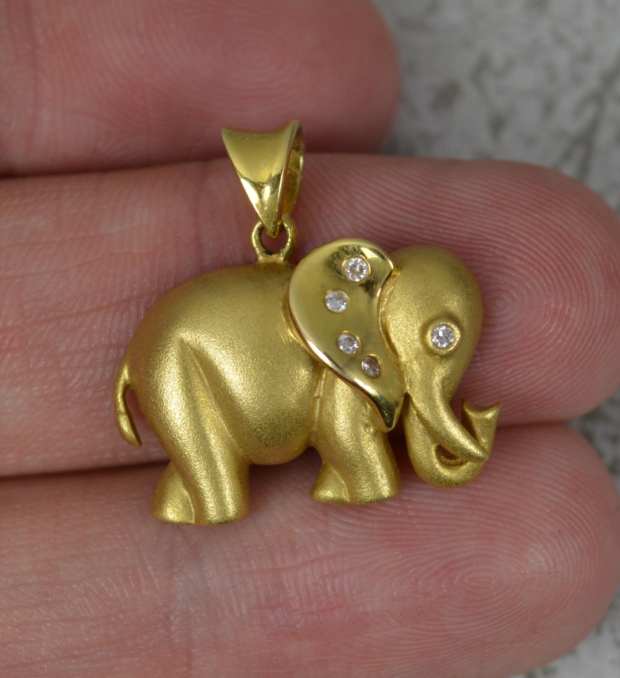 A fine quality pendant in the form of an elephant head.
Well made example with two tone finish to body.
Set with a natural round cut diamond to each eye and a further four to the ear.

CONDITION ; Very good. Crisp design. Well set diamonds. Issue